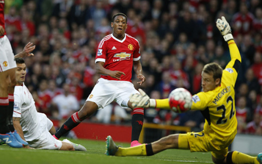 Manchester United's Anthony Martial scores past Liverpool's Simon Mignolet during the English Premier League soccer match between Manchester United and Liverpool at Old Trafford Stadium, Manchester, England, Saturday, Sept. 12, 2015. (AP Photo/Jon Super)