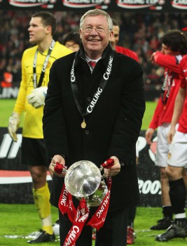 Alex-Ferguson-poses-with-the-Carling-Cup-trophy