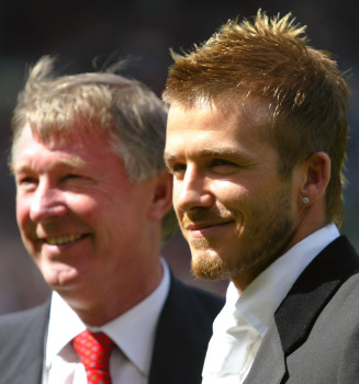 Manchester United's David Beckham (R) stands with manager Sir Alex Ferguson before their match against Charlton Athletic in the English premier league match at Old Trafford ,Manchester, May 11, 2002. Beckham has signed a new three year deal with Manchester United worth 90,000 pounds ($131,600) per week, making him the world's highest-paid footballer, following a year of negotiations with the Old Trafford club. width=