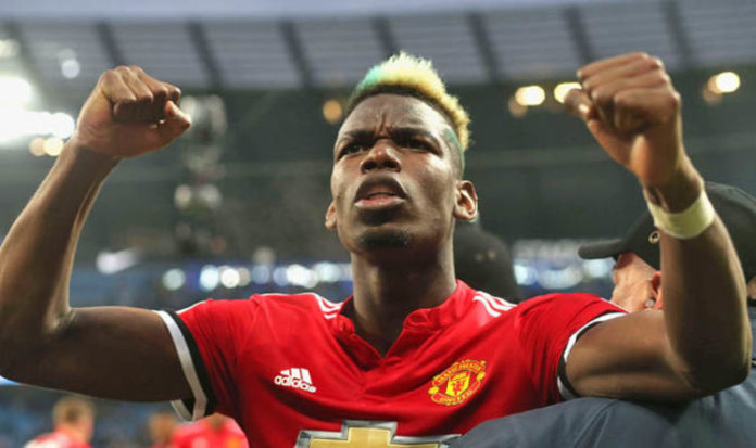 Paul Pogba is restrained from celebrating with Manchester United fans after the Manchester Derby.