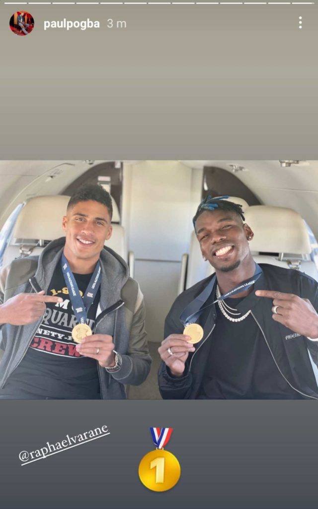 (Photo) Pogba and Varane show off medals on flight back to Manchester