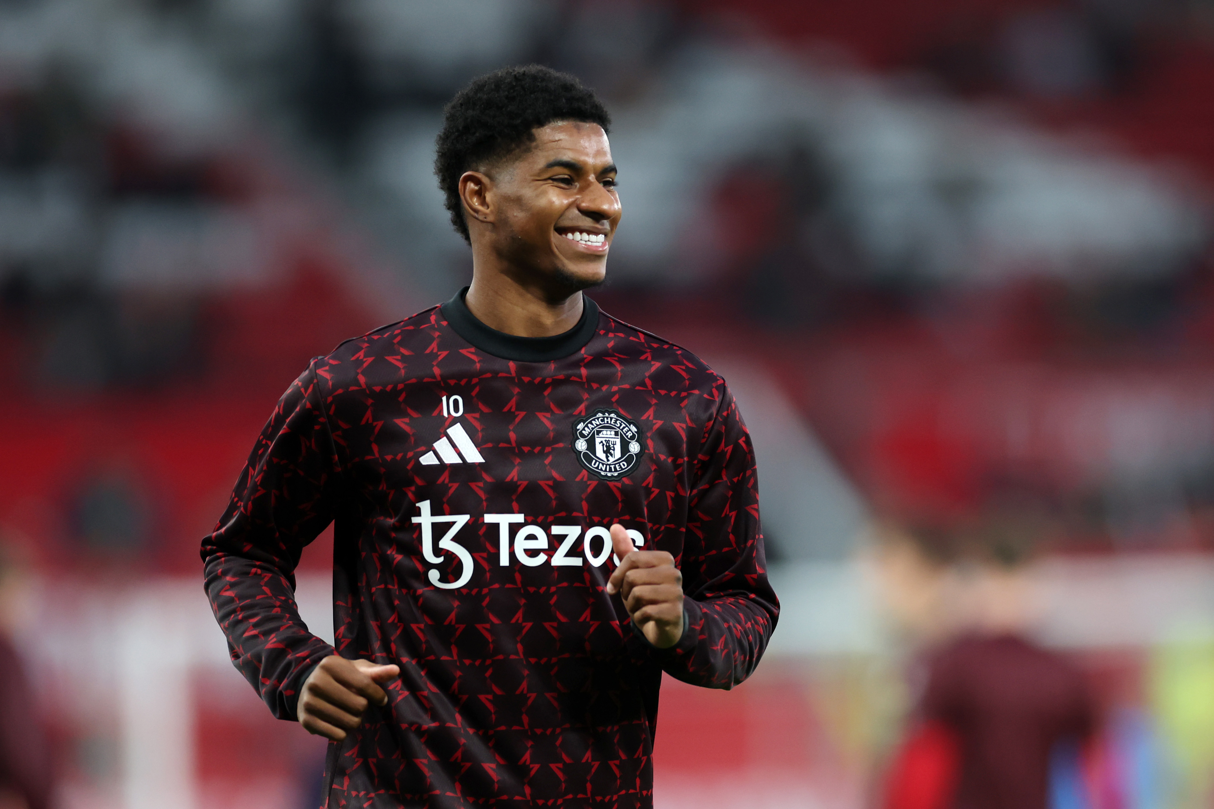 Marcus Rashford warms up ahead of kick-off at Old Trafford.