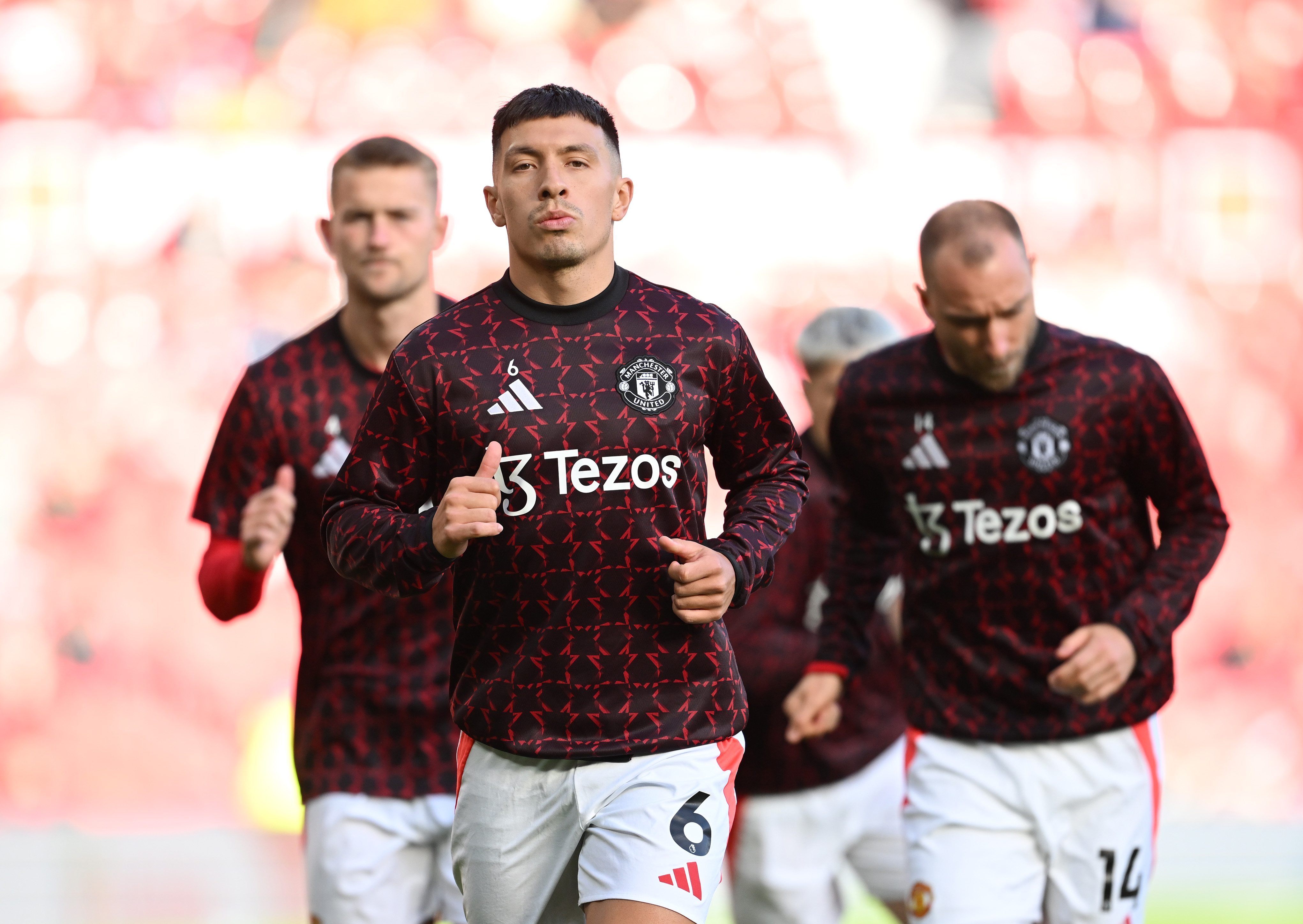 Lisandro Martinez warms up prior to kick-off at Old Trafford.