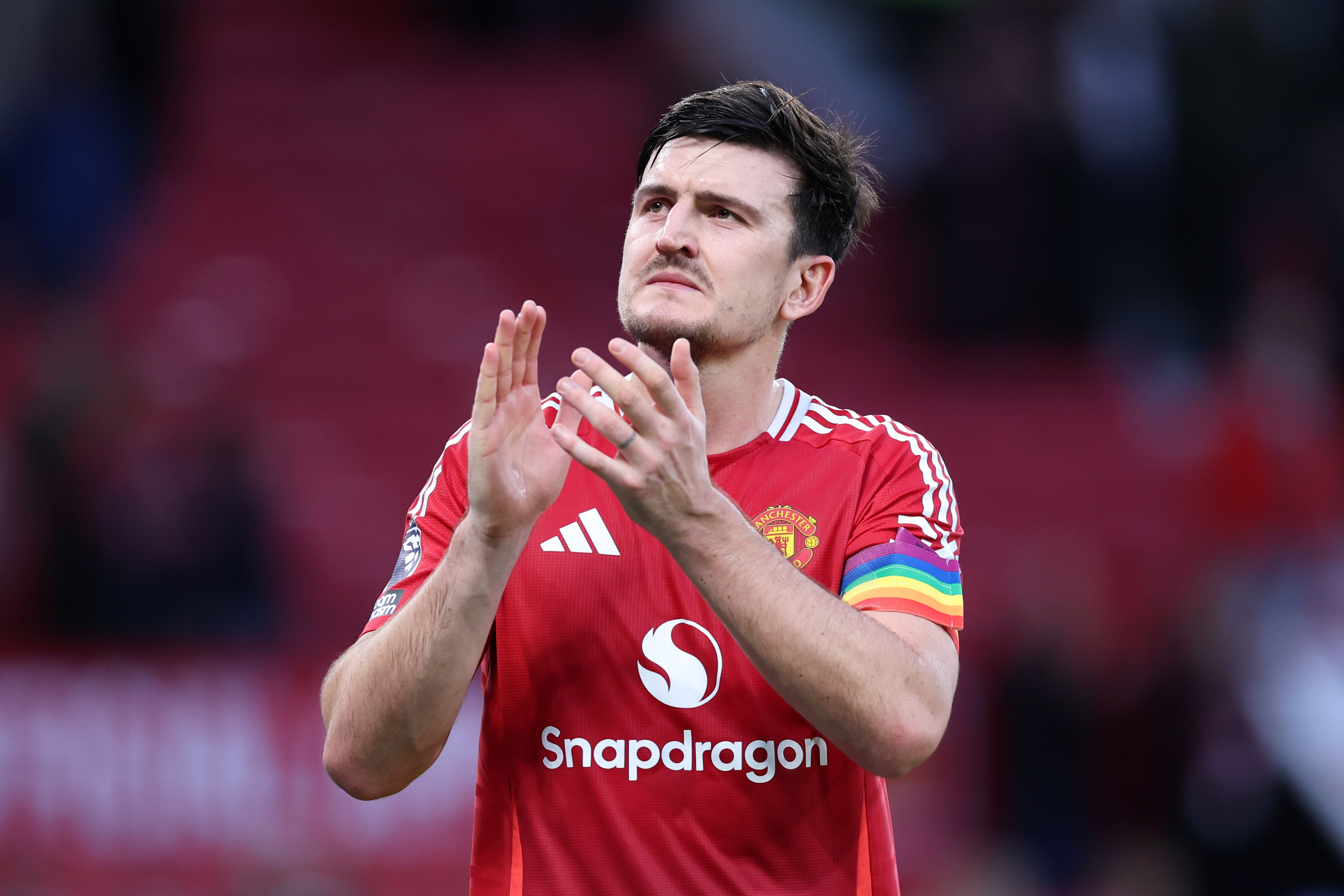 Harry Maguire applauds the Man Utd fans.