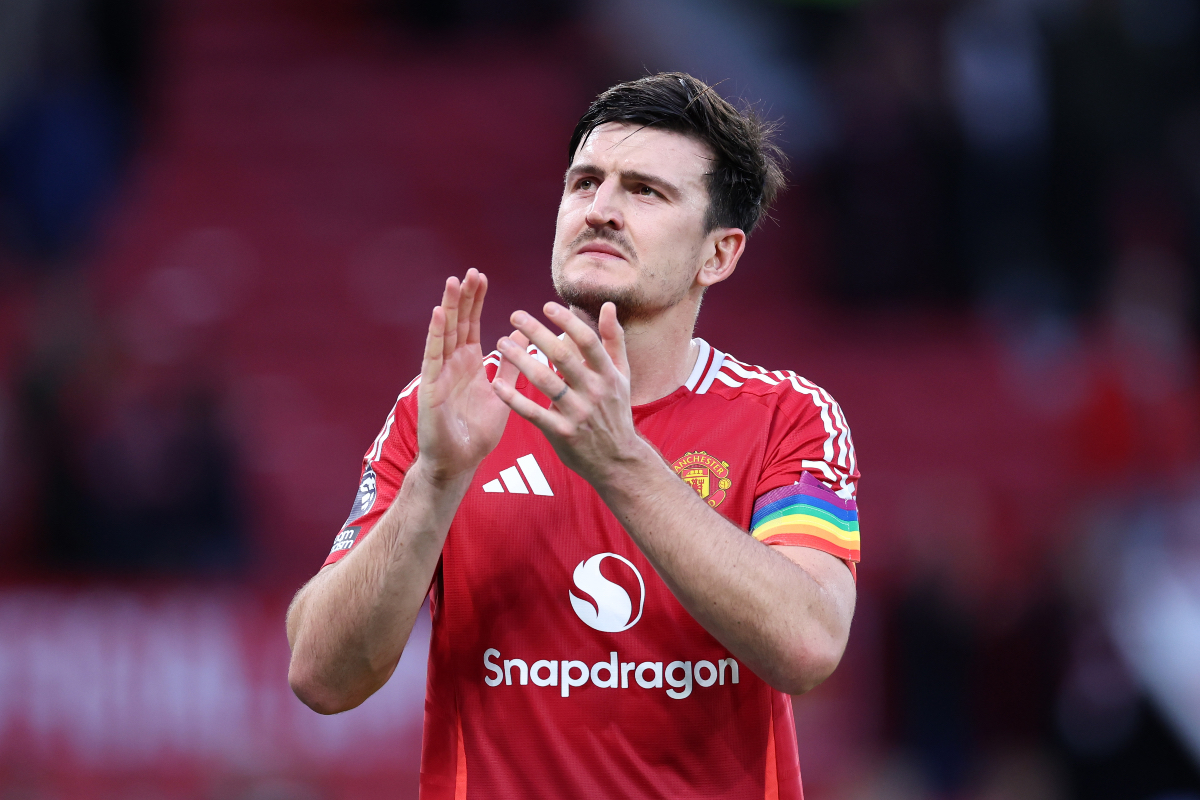 Harry Maguire applauds the fans at Old Trafford.