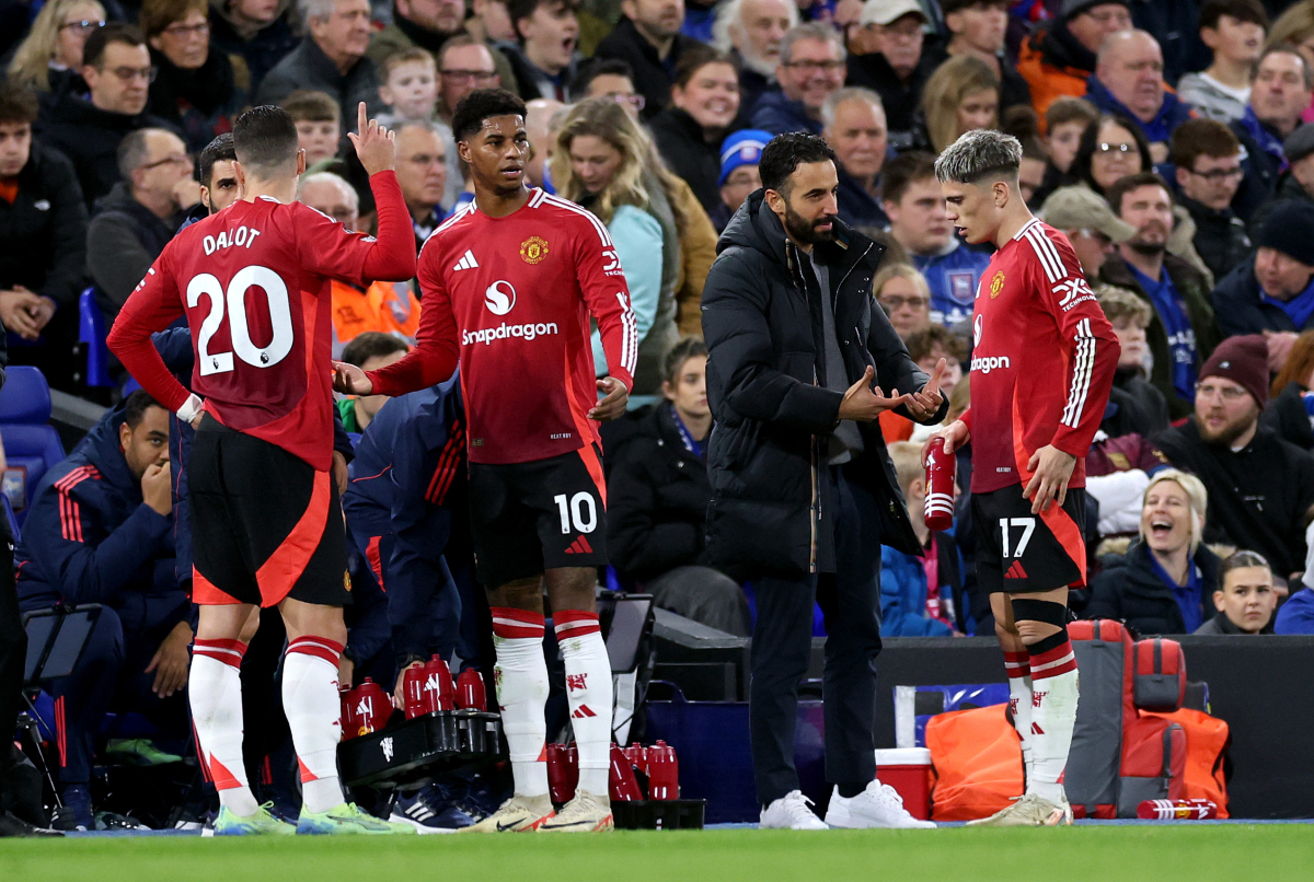 Diogo Dalot takes instructions from the coaching staff.