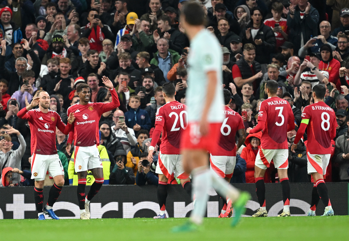 Christian Eriksen celebrates with Rashford.