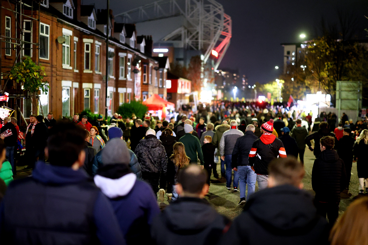 A view of Manchester United fans walking down the street to Old Trafford.