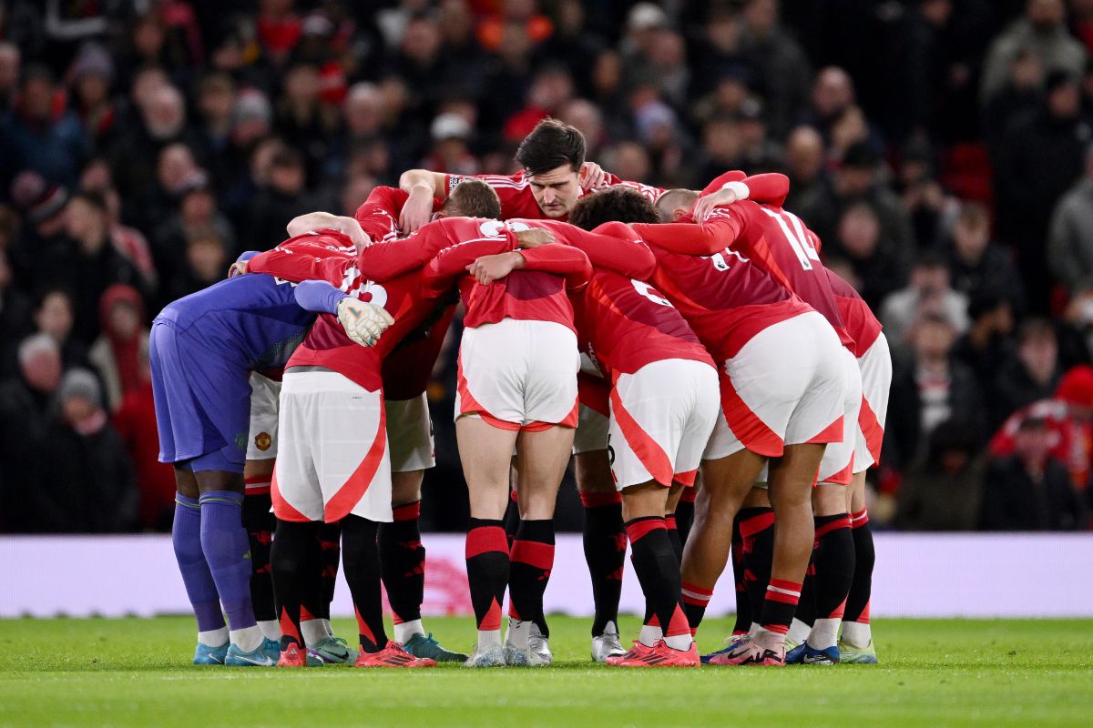 Manchester United players huddle ahead of kick-off at Old Trafford.