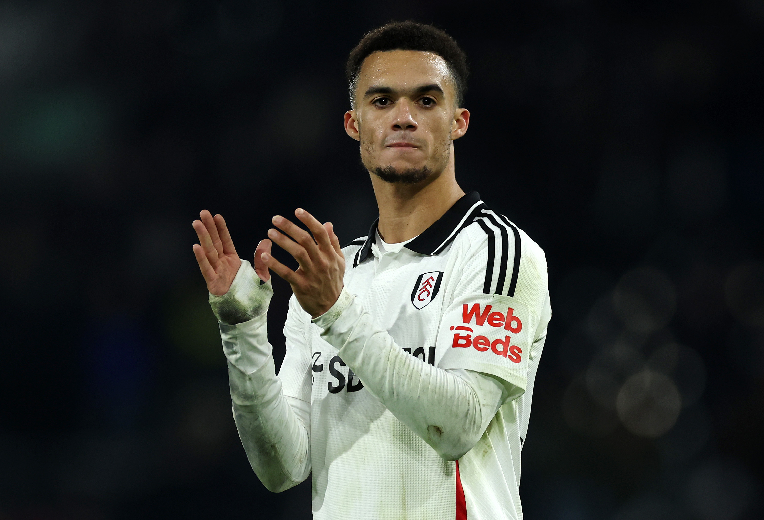 Antonee Robinson applauds the Fulham fans.