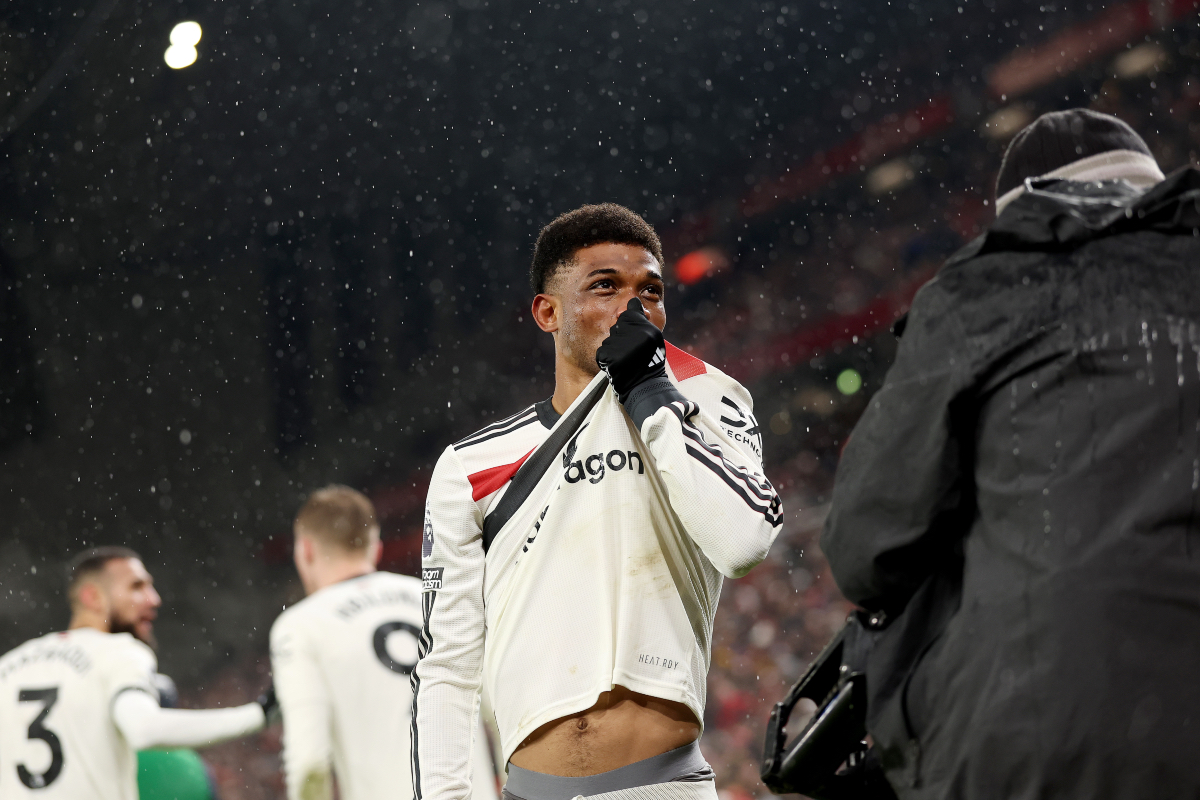 Amad Diallo kisses the Man United badge in front of the travelling fans.