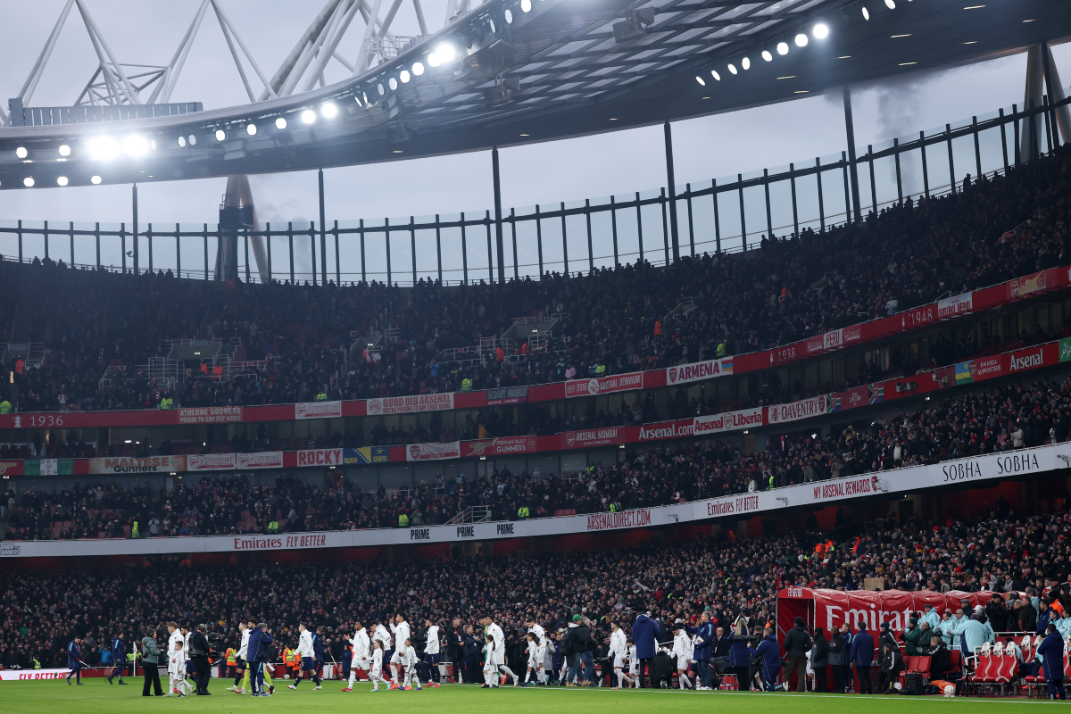 United and Arsenal players walk out at the Emirates Stadium prior to kick-off.