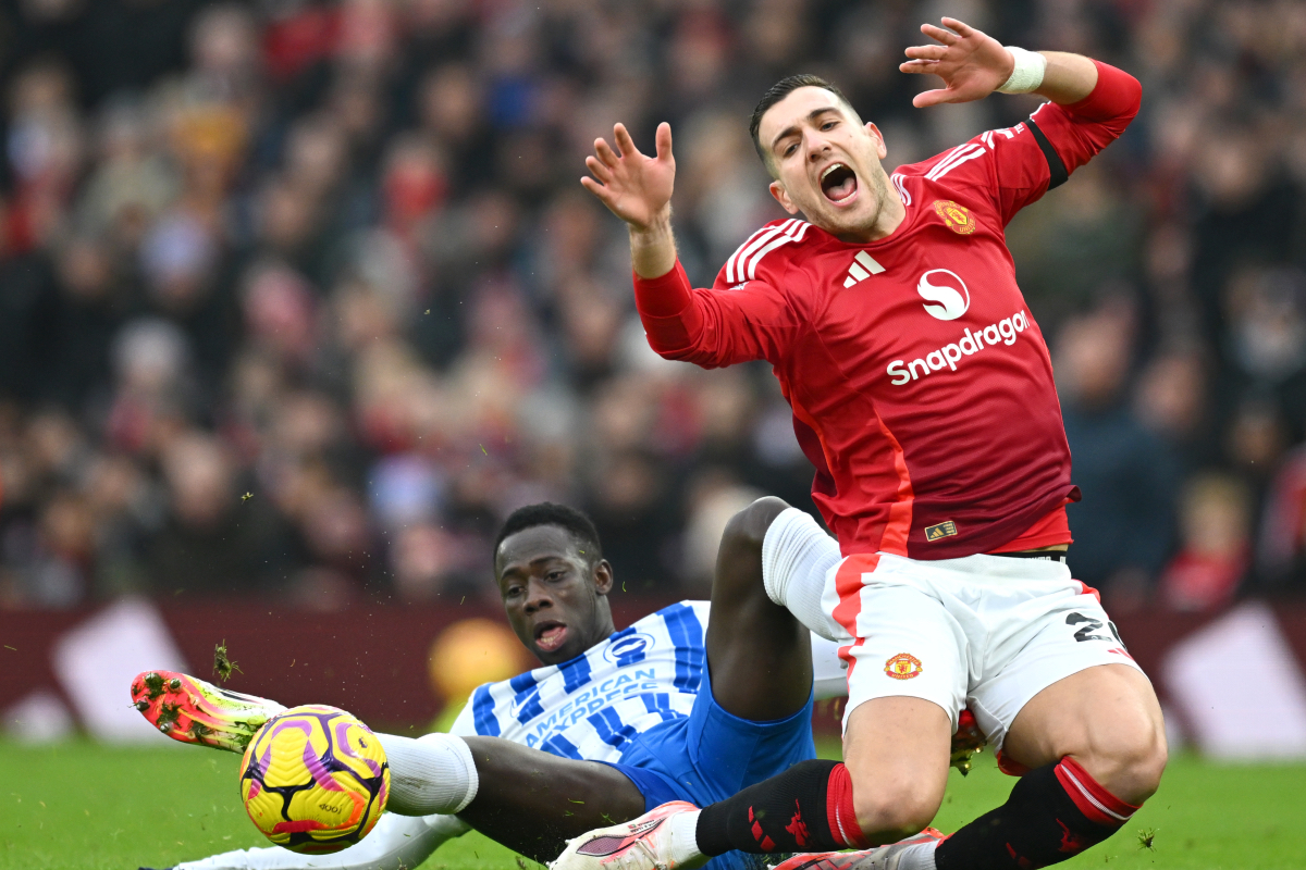 Diogo Dalot is challenged by Yankuba Minteh at Old Trafford.