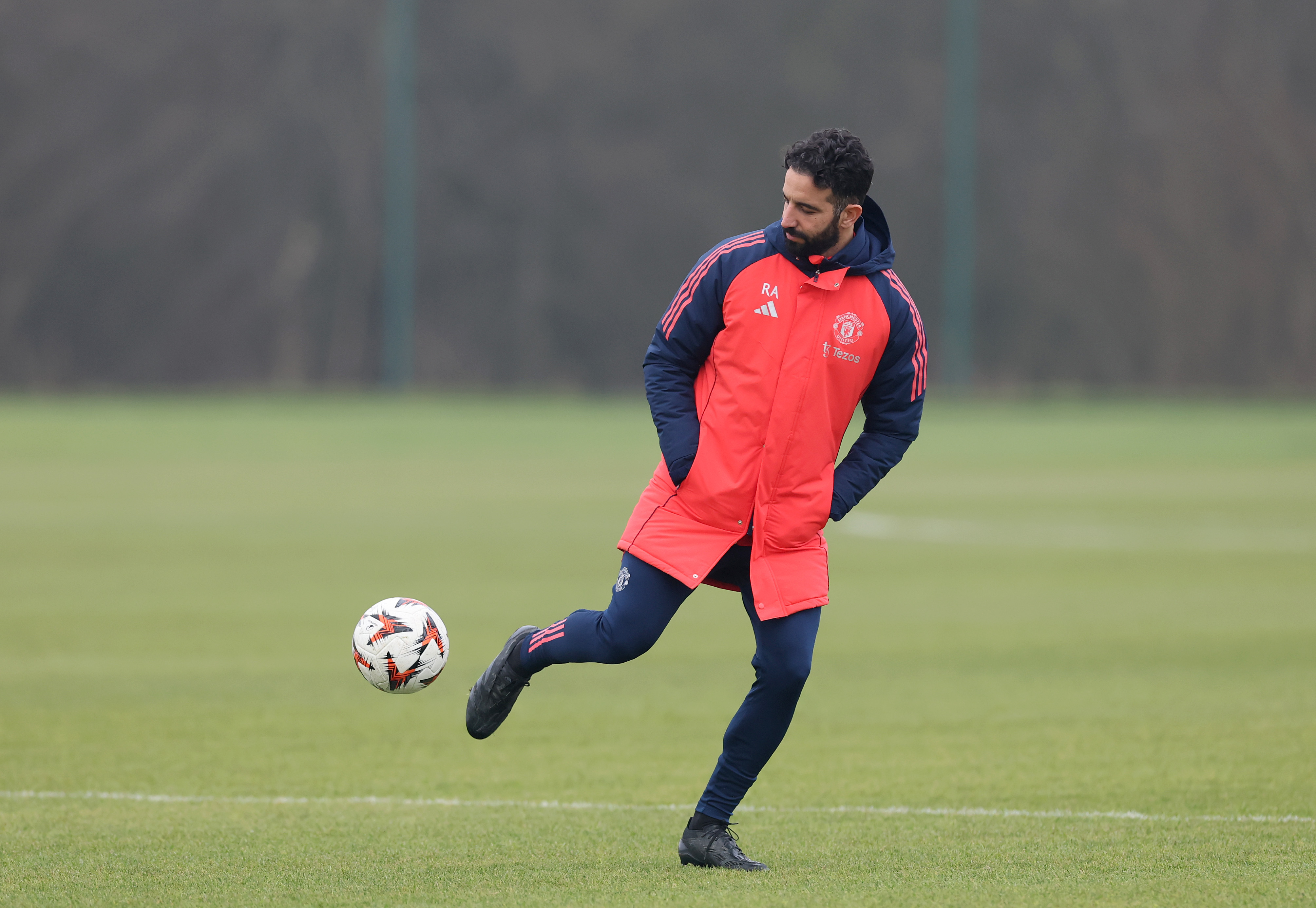 Ruben Amorim plays with the ball while watching Man United training at Carrington.