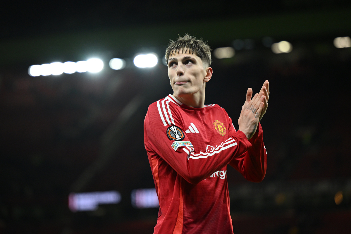 Alejandro Garnacho applauds the fans as he leaves the Old Trafford pitch.