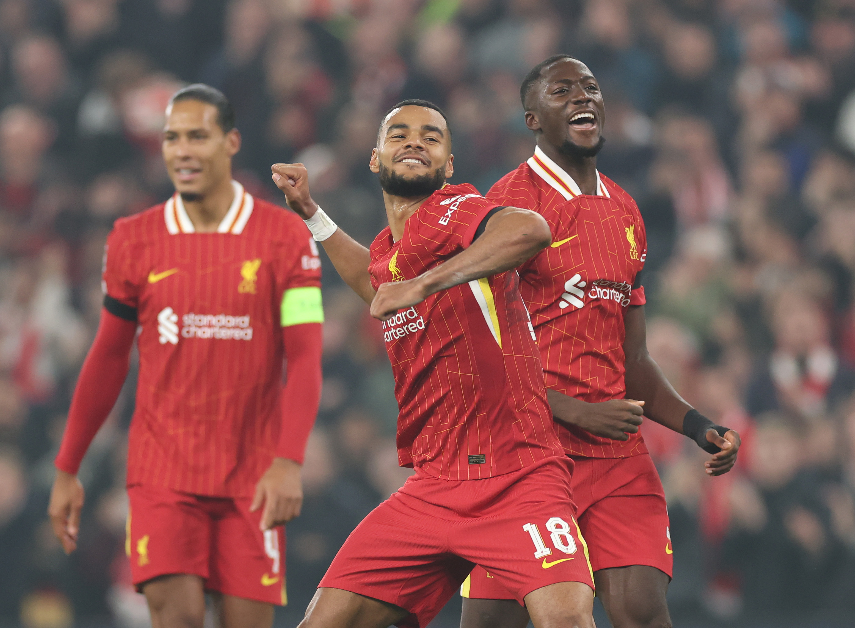 Cody Gakpo celebrates his goal against Bayer Leverkusen with Ibrahima Konate and Virgil van Dijk.