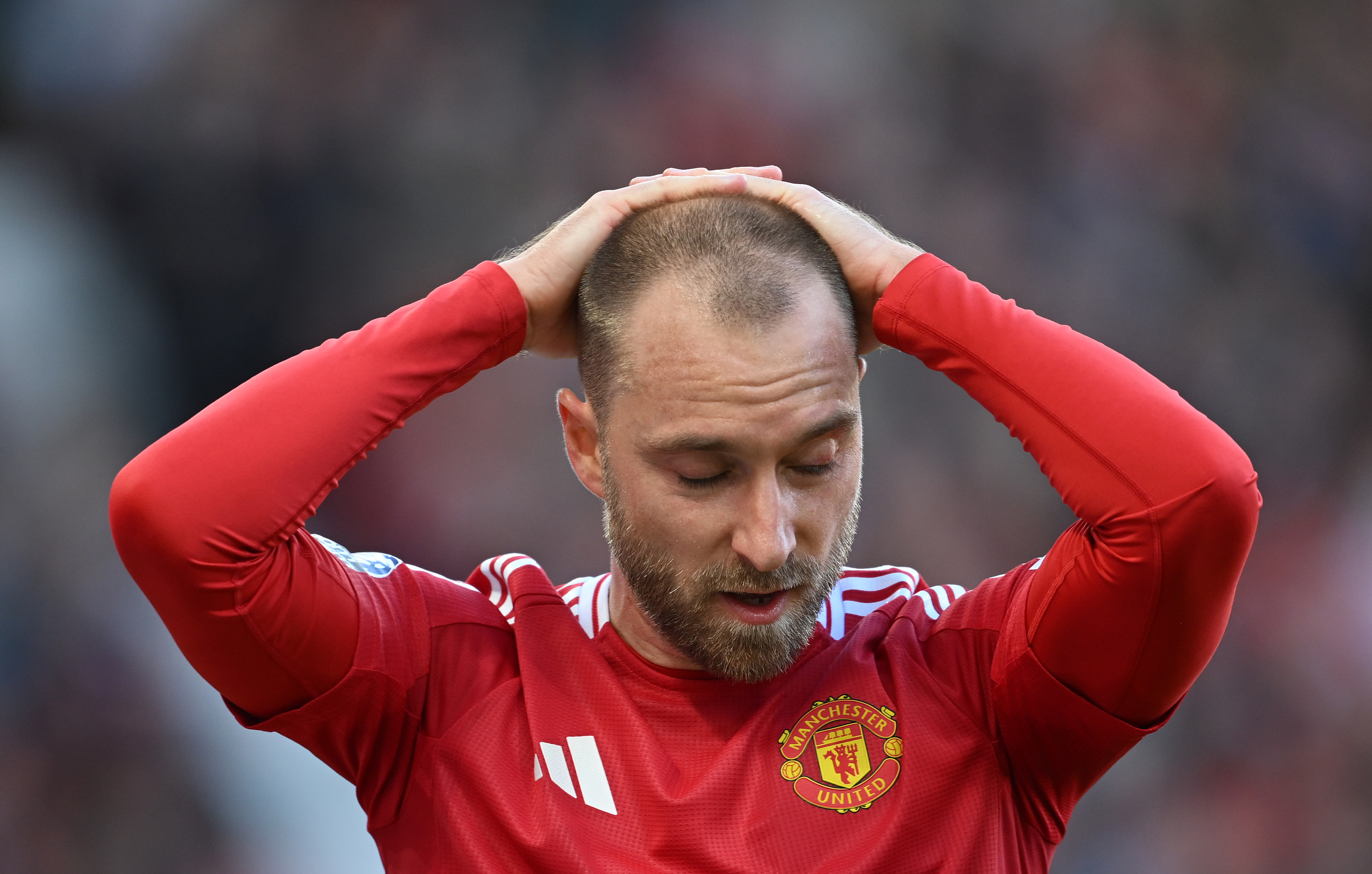 Eriksen reacts while in action for United against former club, Brentford. 