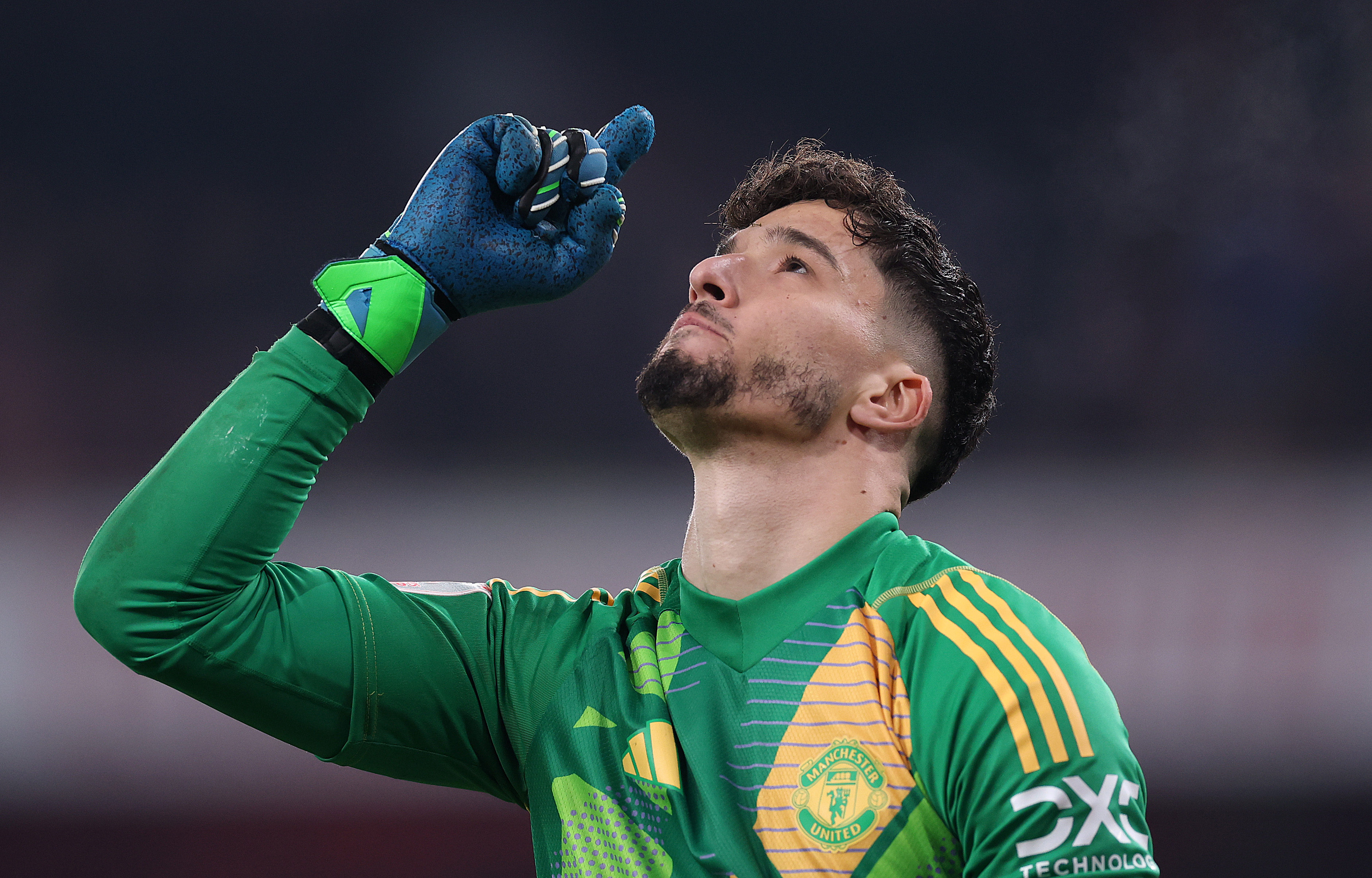 Altay Bayindir celebrates after saving a penalty against Arsenal.