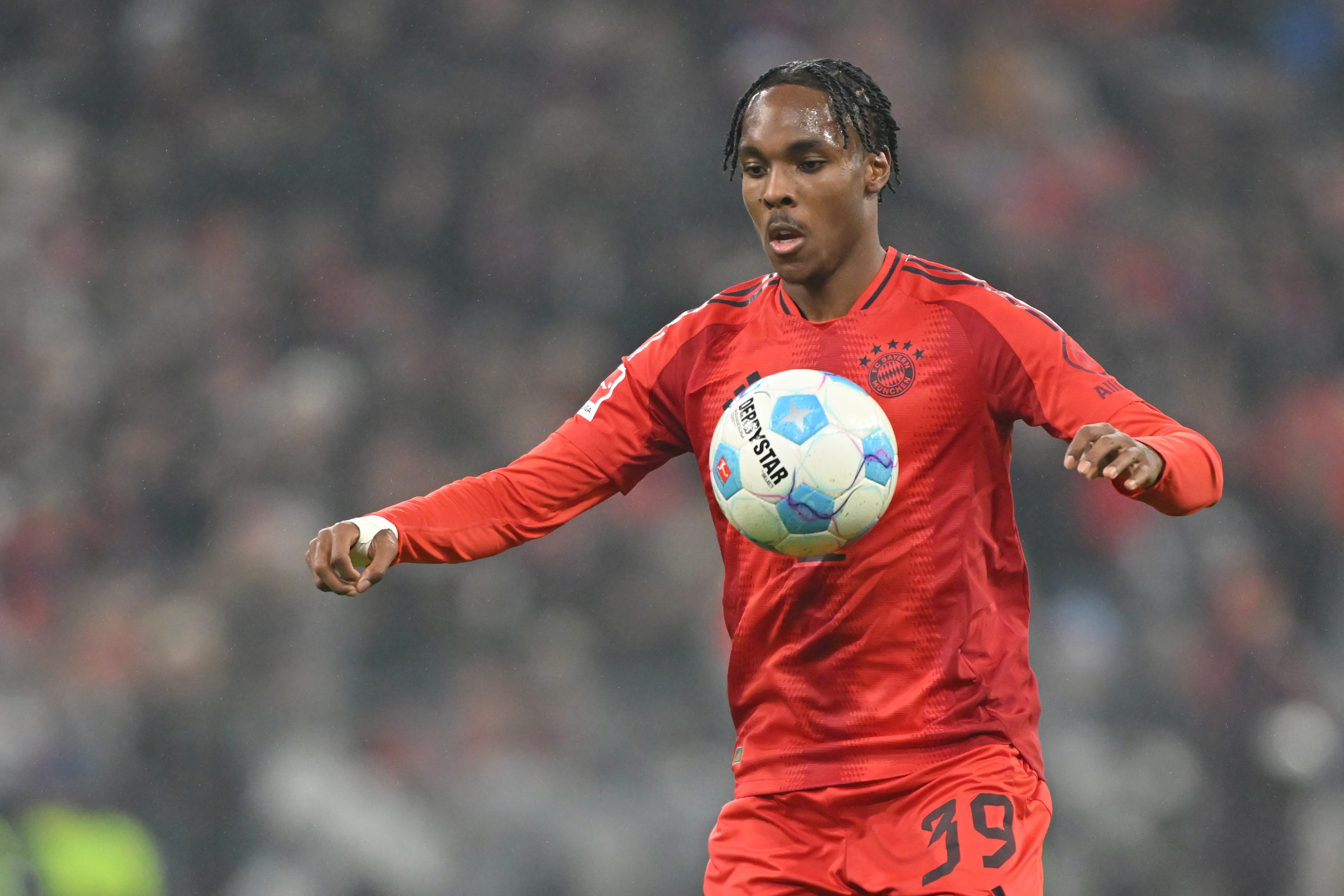 Mathys Tel controls the ball while in action for Bayern Munich.