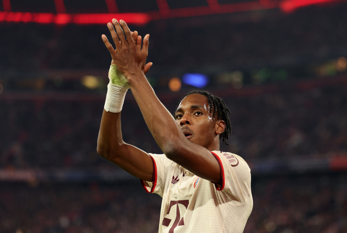 Mathys Tel applauds Bayern Munich supporters.