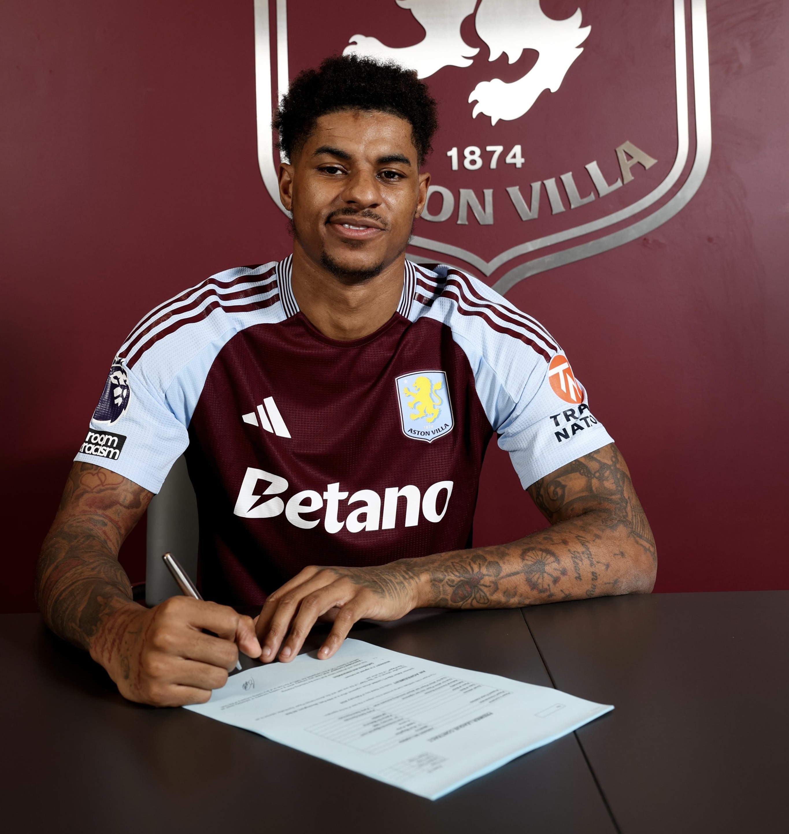 Marcus Rashford is pictured signing his Aston Villa contract after signing on loan.