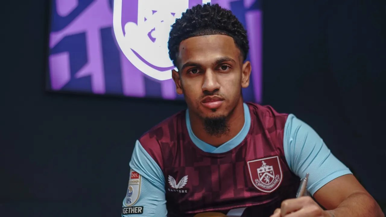 Marcus Edwards signs his Burnley contract.