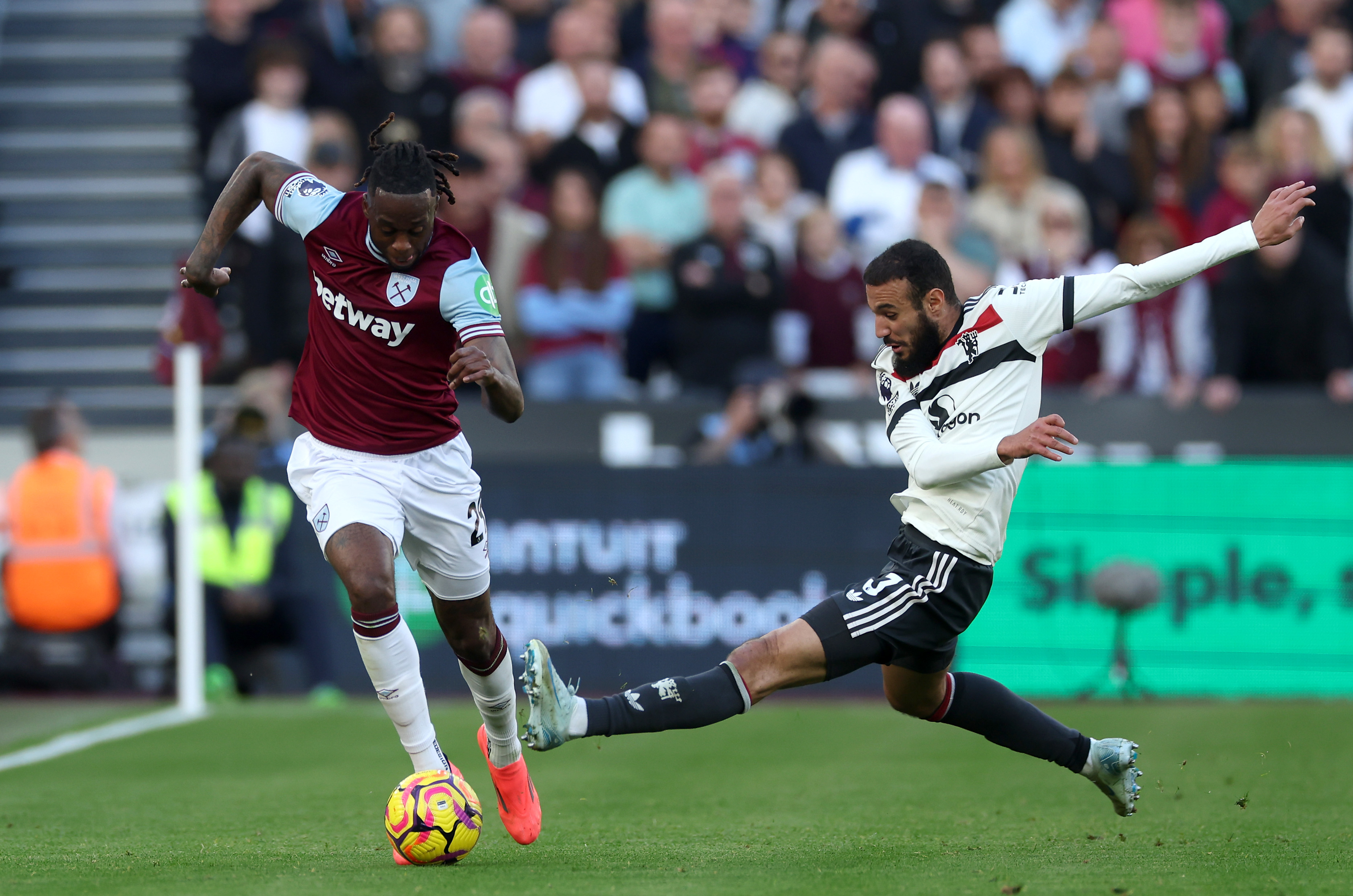 Aaron Wan-Bissaka is challenged by Noussair Mazraoui, who replaced him at Man United