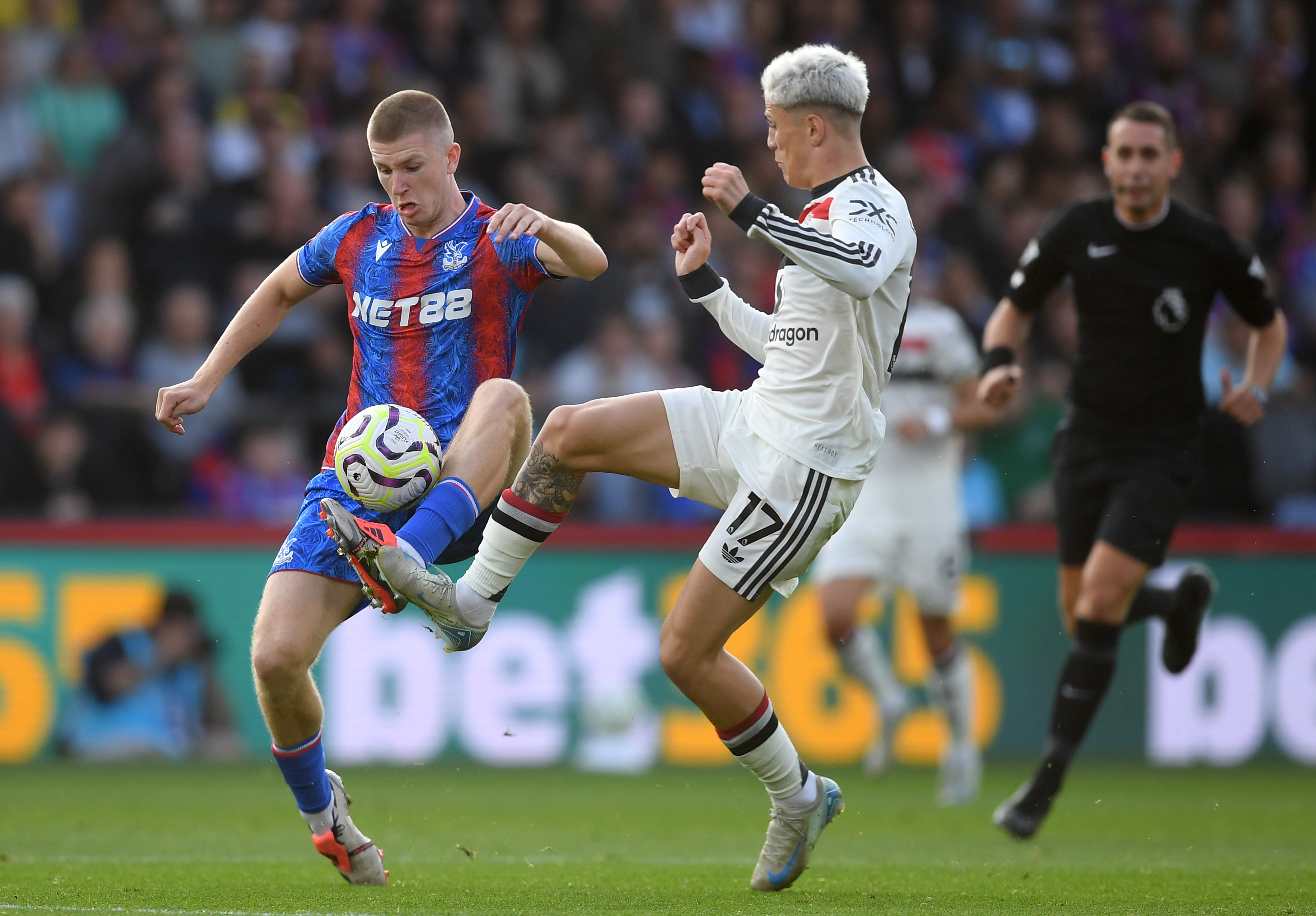 Adam Wharton vies with Alejandro Garnacho during Palace vs United at Selhurst Park.