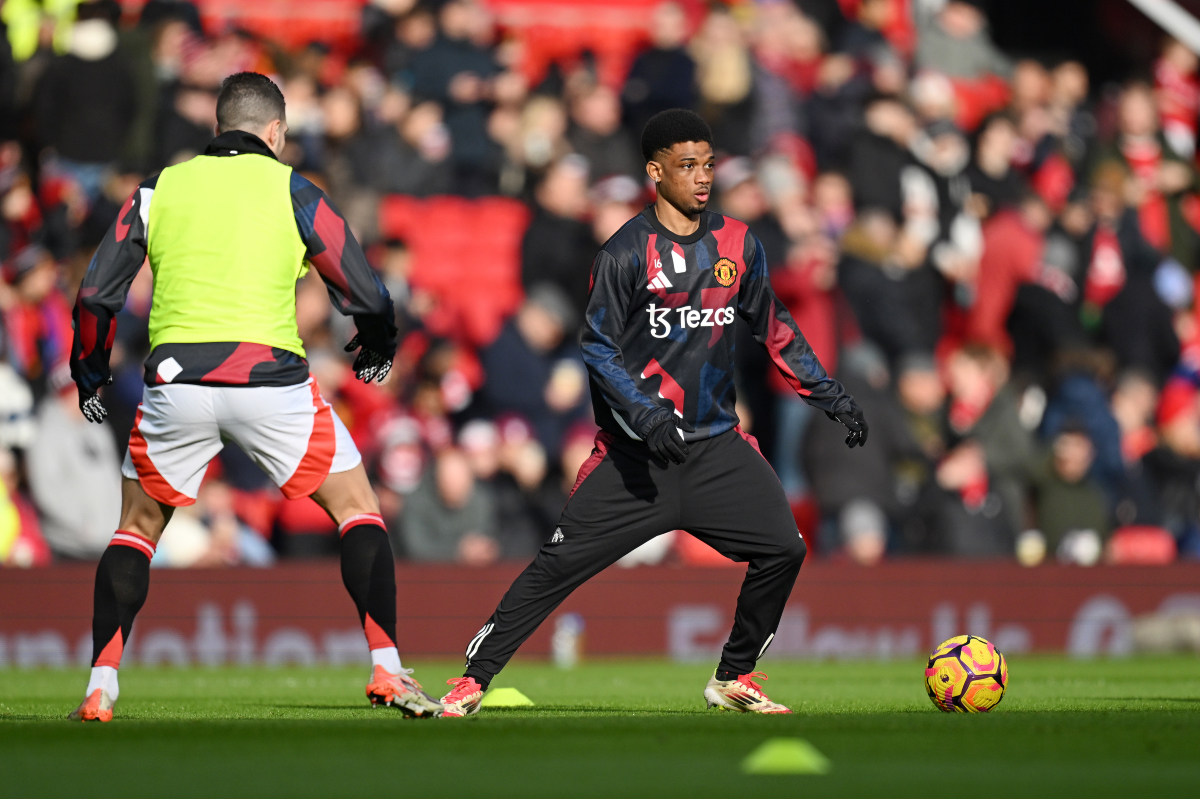 Amad Diallo warms up ahead of kick-off at Old Trafford.