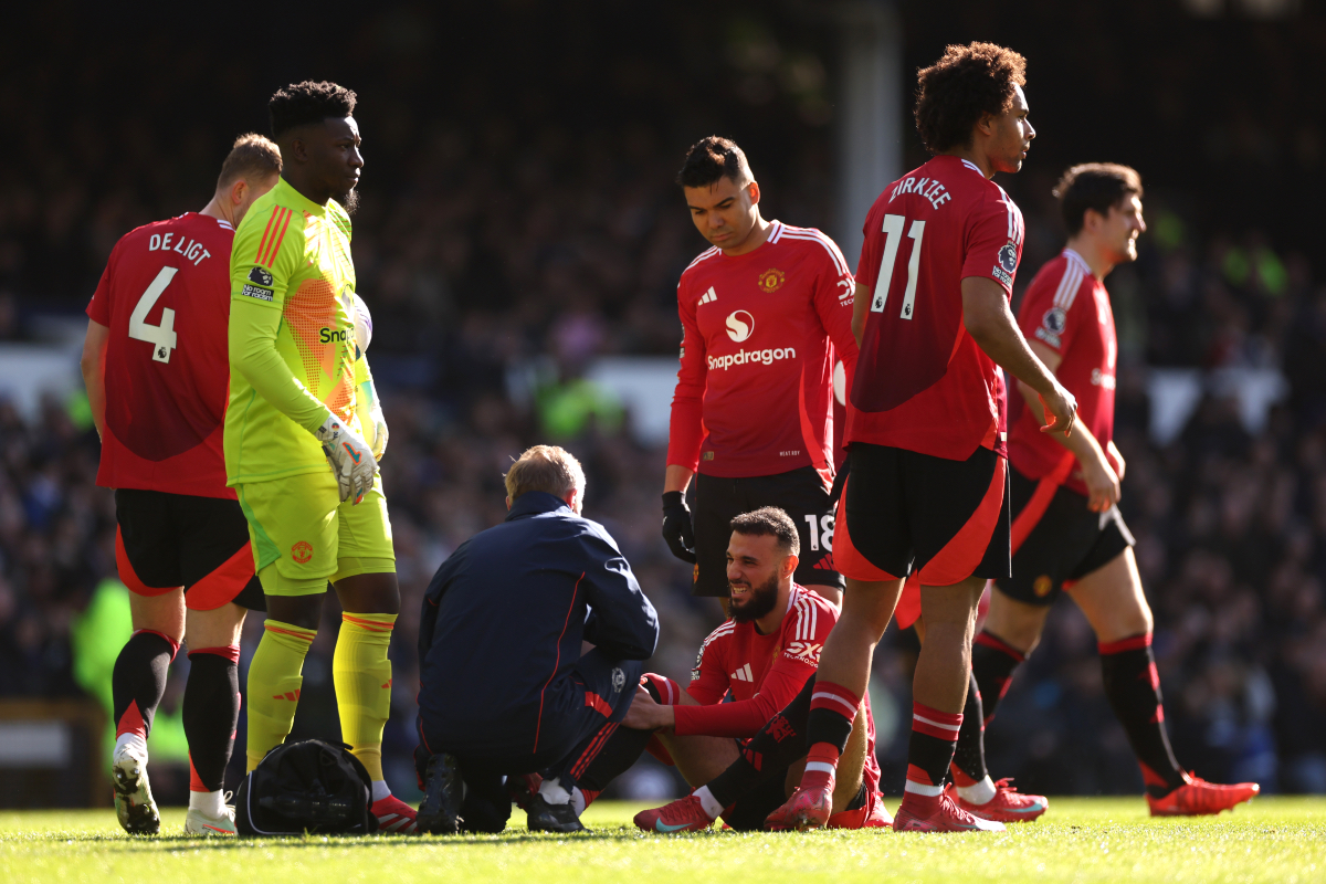 Noussair Mazraoui receives treatment from the Man United medical staff.