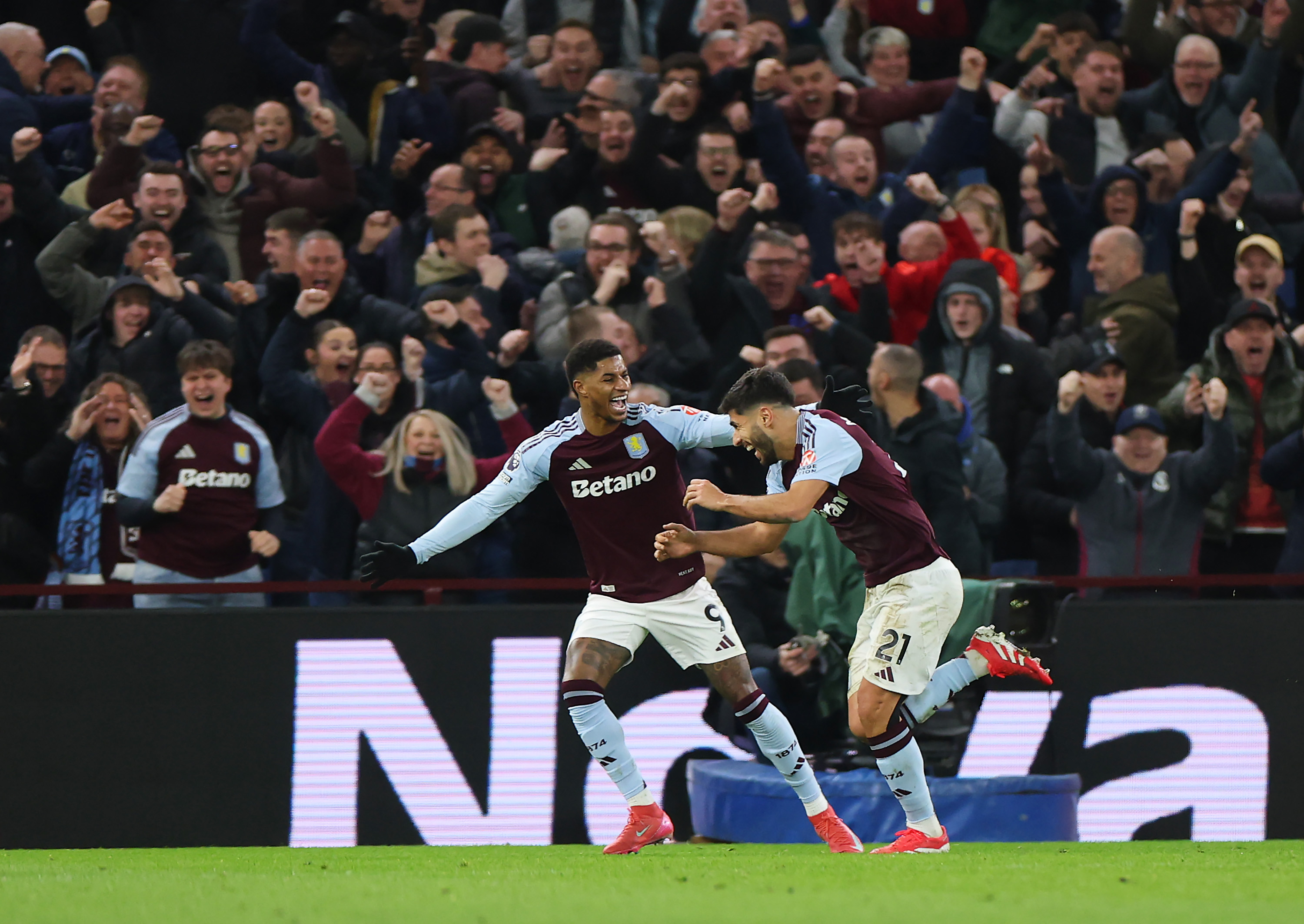 Marcus Rashford celebrates with Marco Asensio after assisting the forward for two Aston Villa goals.