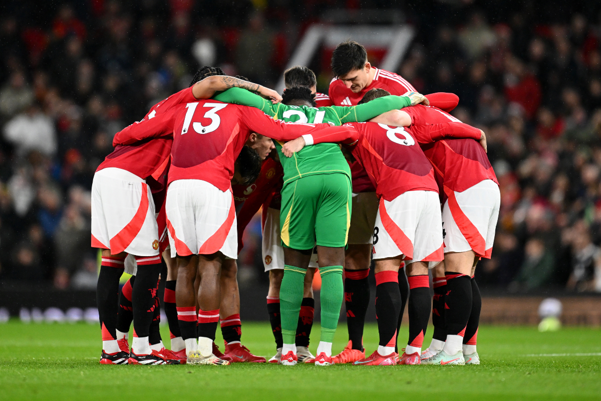 Manchester United players huddle ahead of kick-off at Old Trafford.