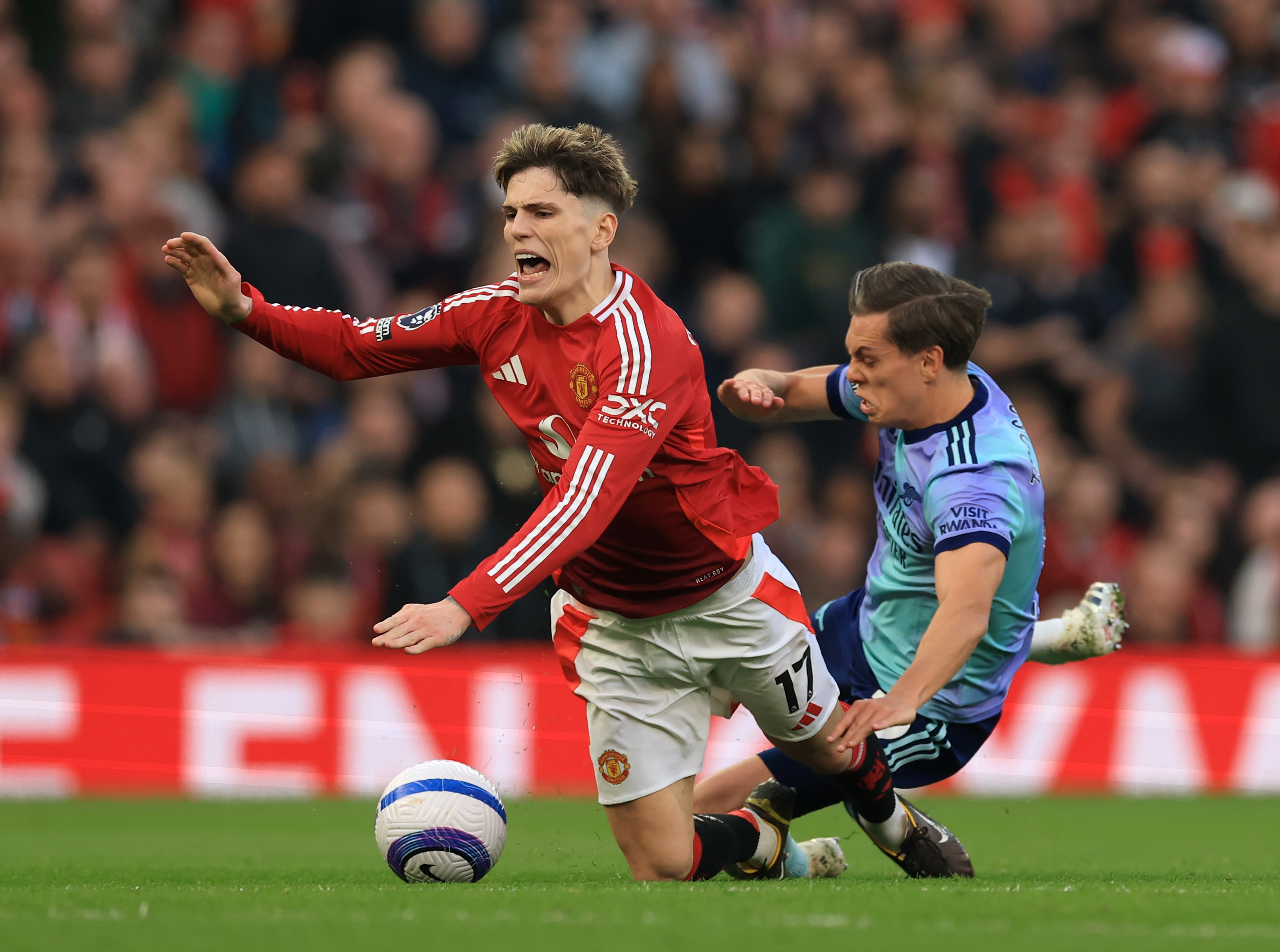 Alejandro Garnacho falls to the ground after Leandro Trossard tackle.