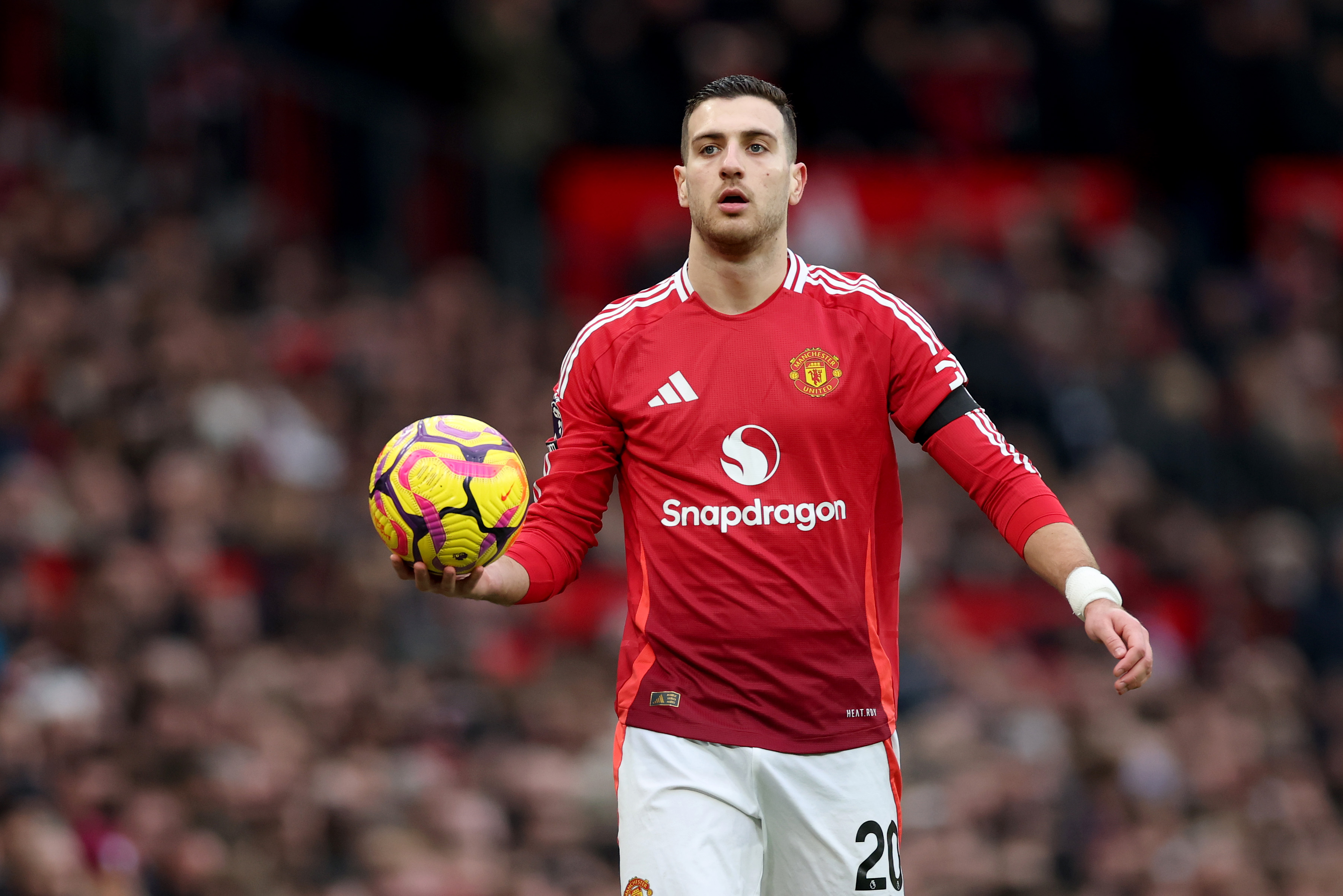 Diogo Dalot takes a throw-in.