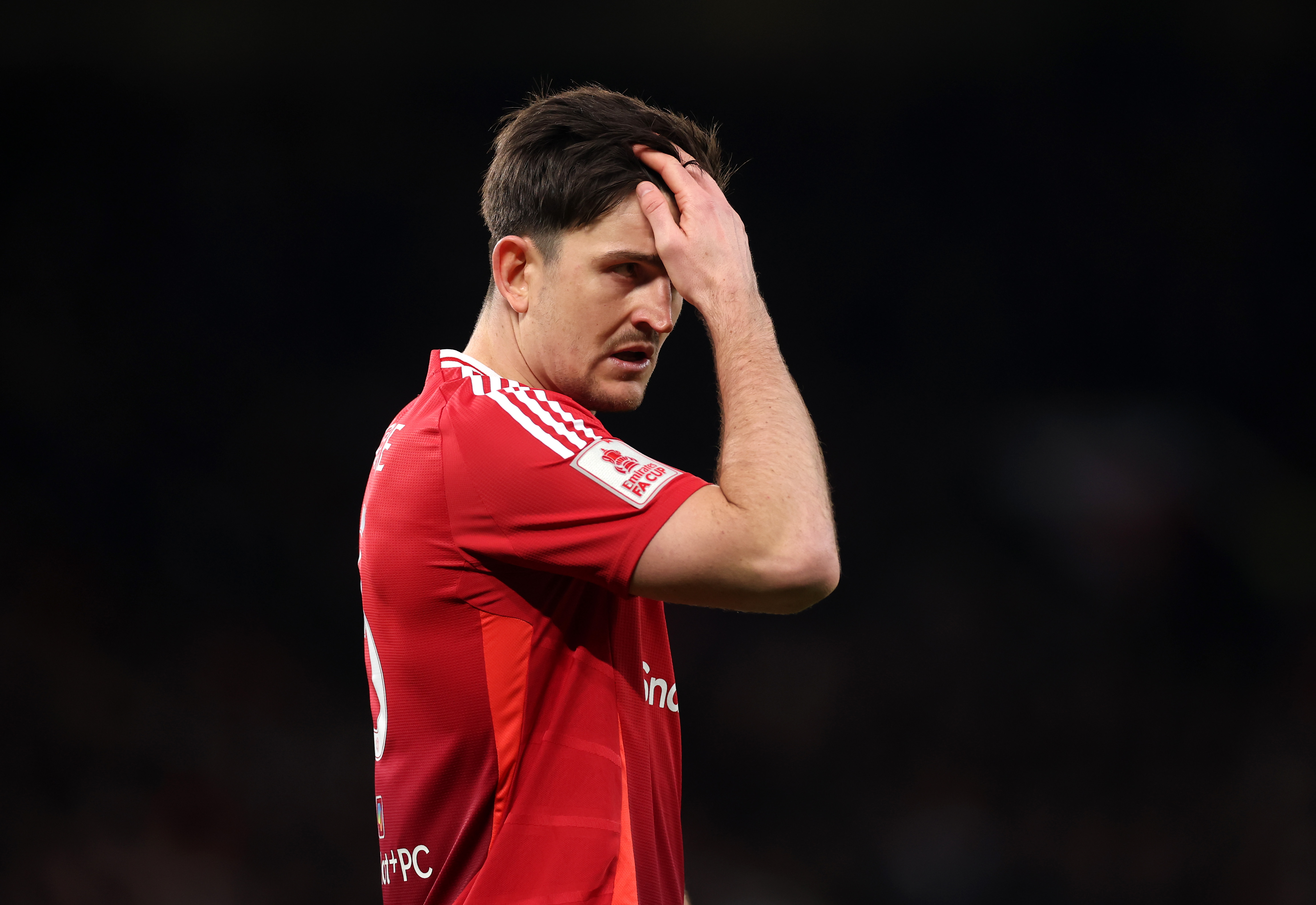 Harry Maguire looks on while in action for Man United.