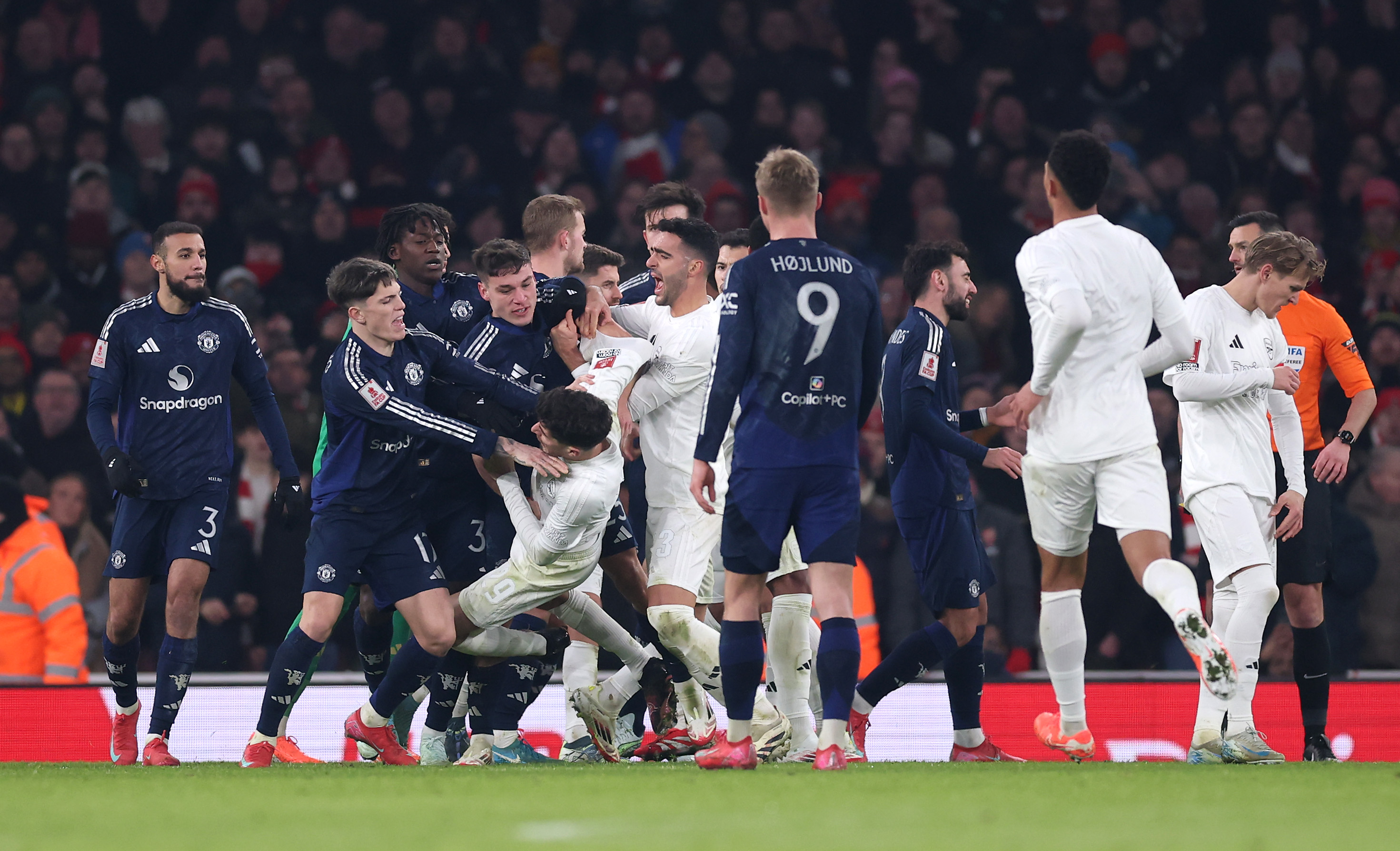 Manchester United and Arsenal players clash while in FA Cup action.