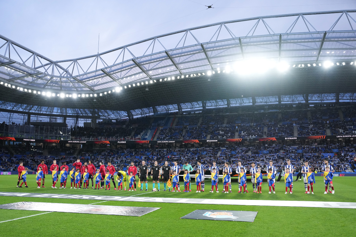 Manchester United and Real Sociedad players line up ahead of kick-off.