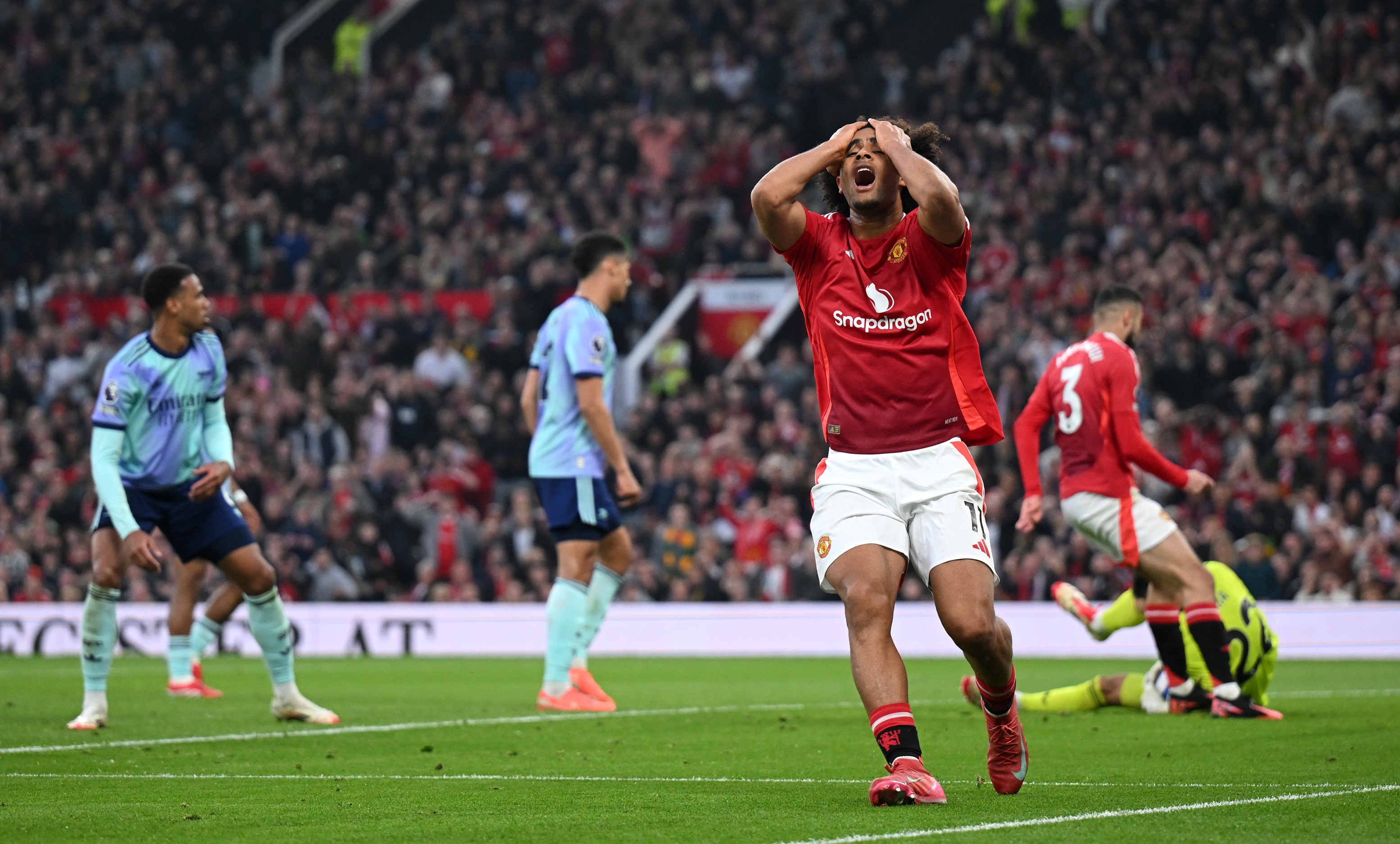 Joshua Zirkzee holds his head in disappointment at Old Trafford.