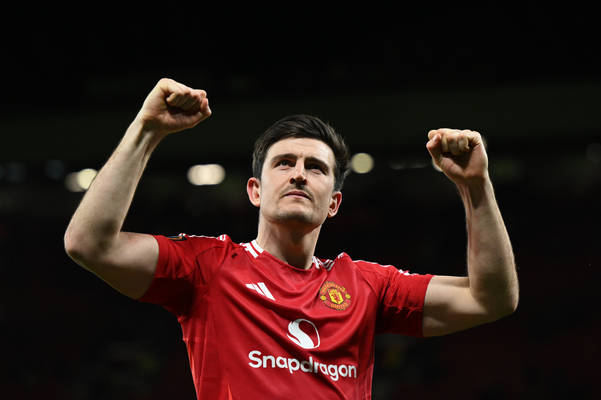 Harry Maguire celebrates after scoring an injury-time winner against Lyon at Old Trafford.