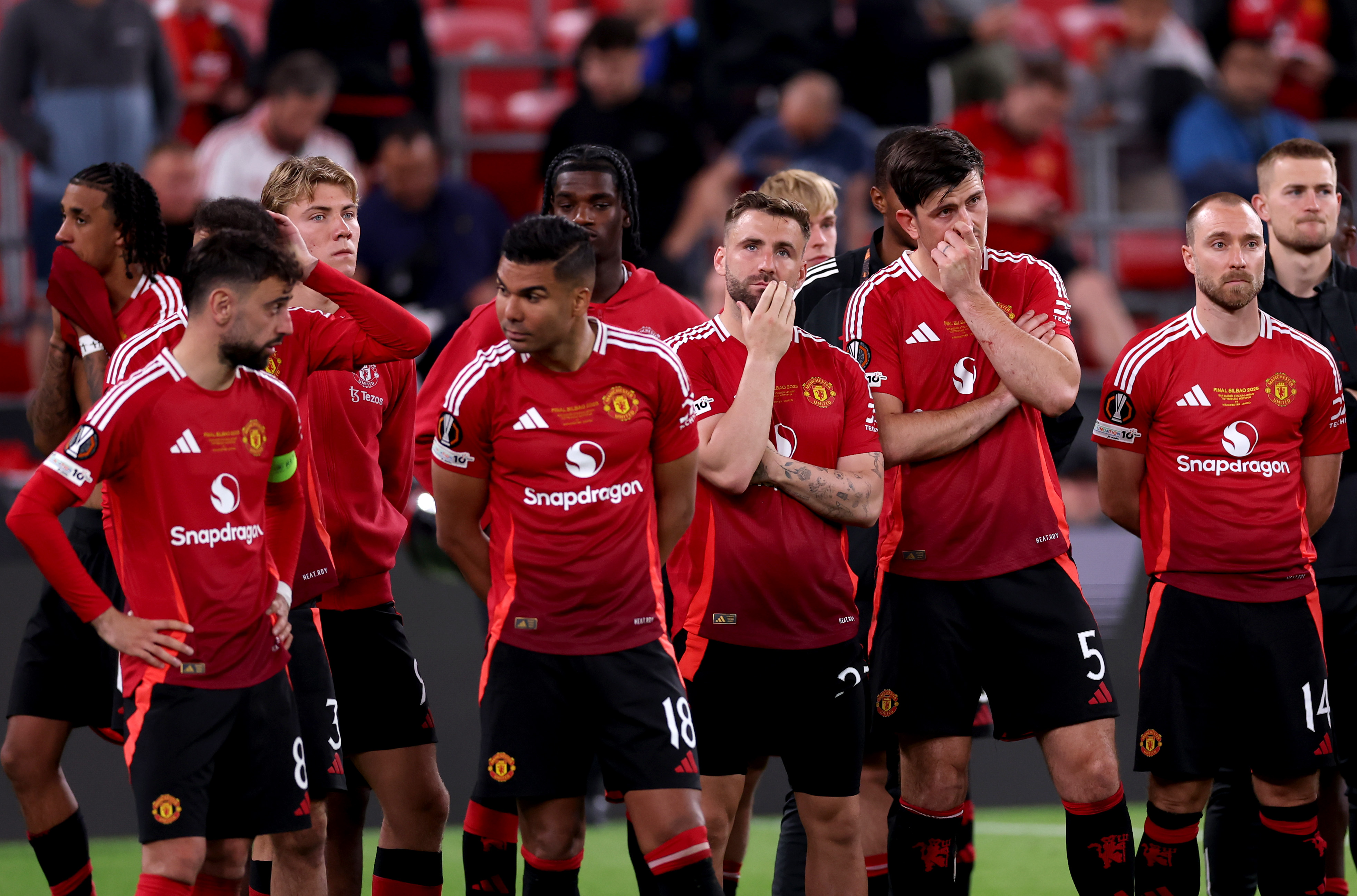 Man United players look dejected as they wait to collect their runners-up medals after losing the Europa League final.
