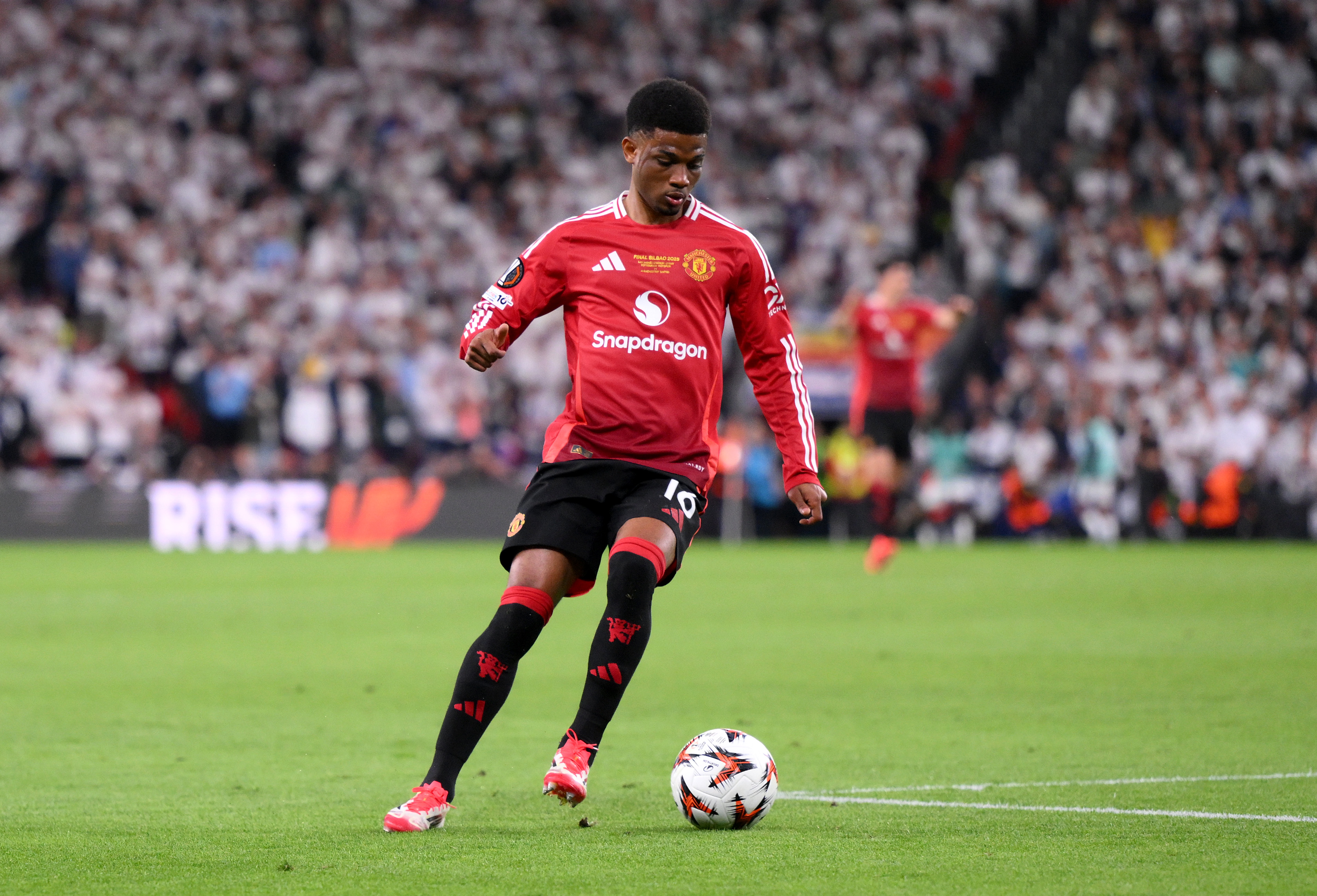 Amad carries the ball while in action for Man United against Spurs in the Europa League final.