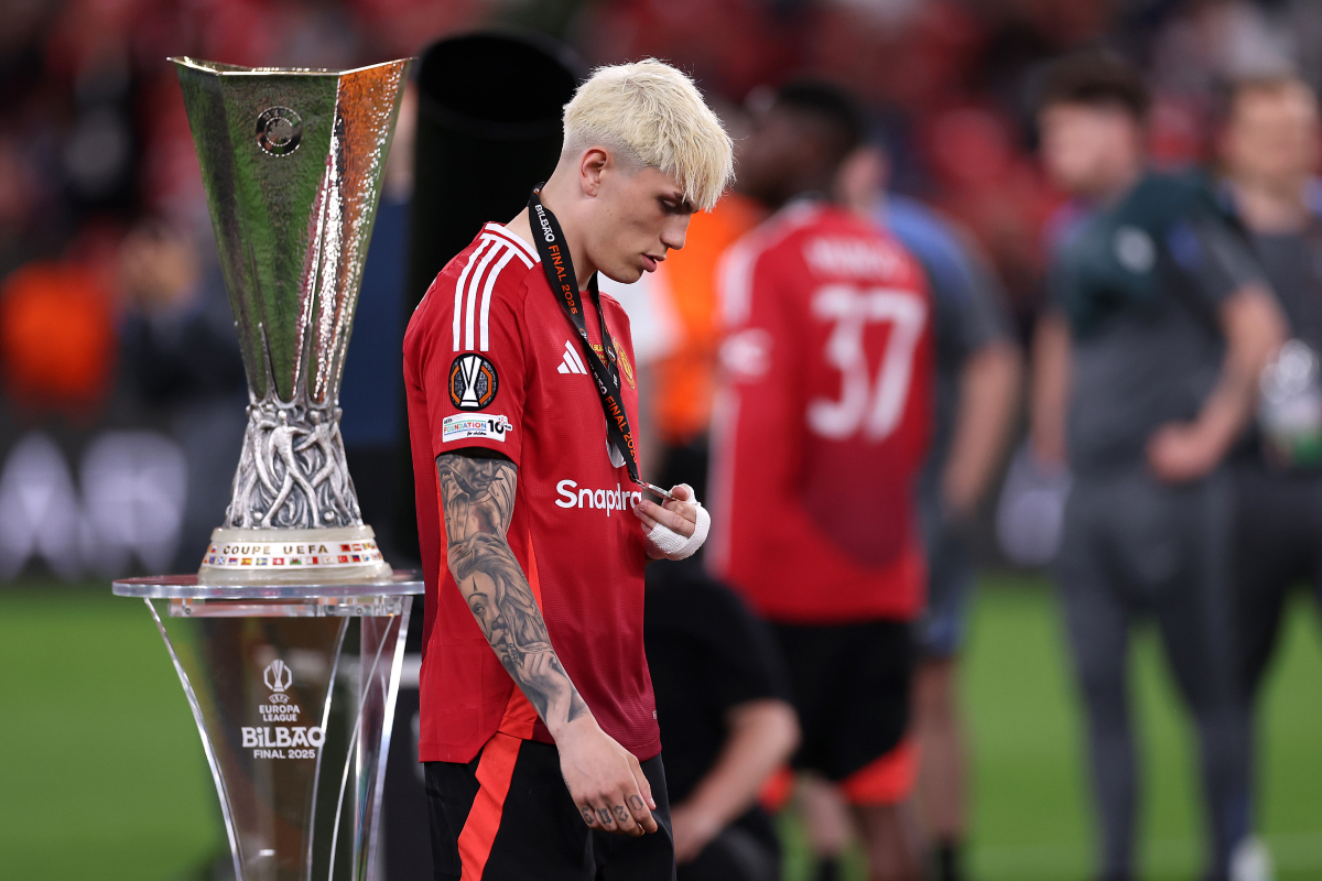 Alejandro Garnacho looks dejected as walks past the Europa League trophy after receiving his runners-up medal.