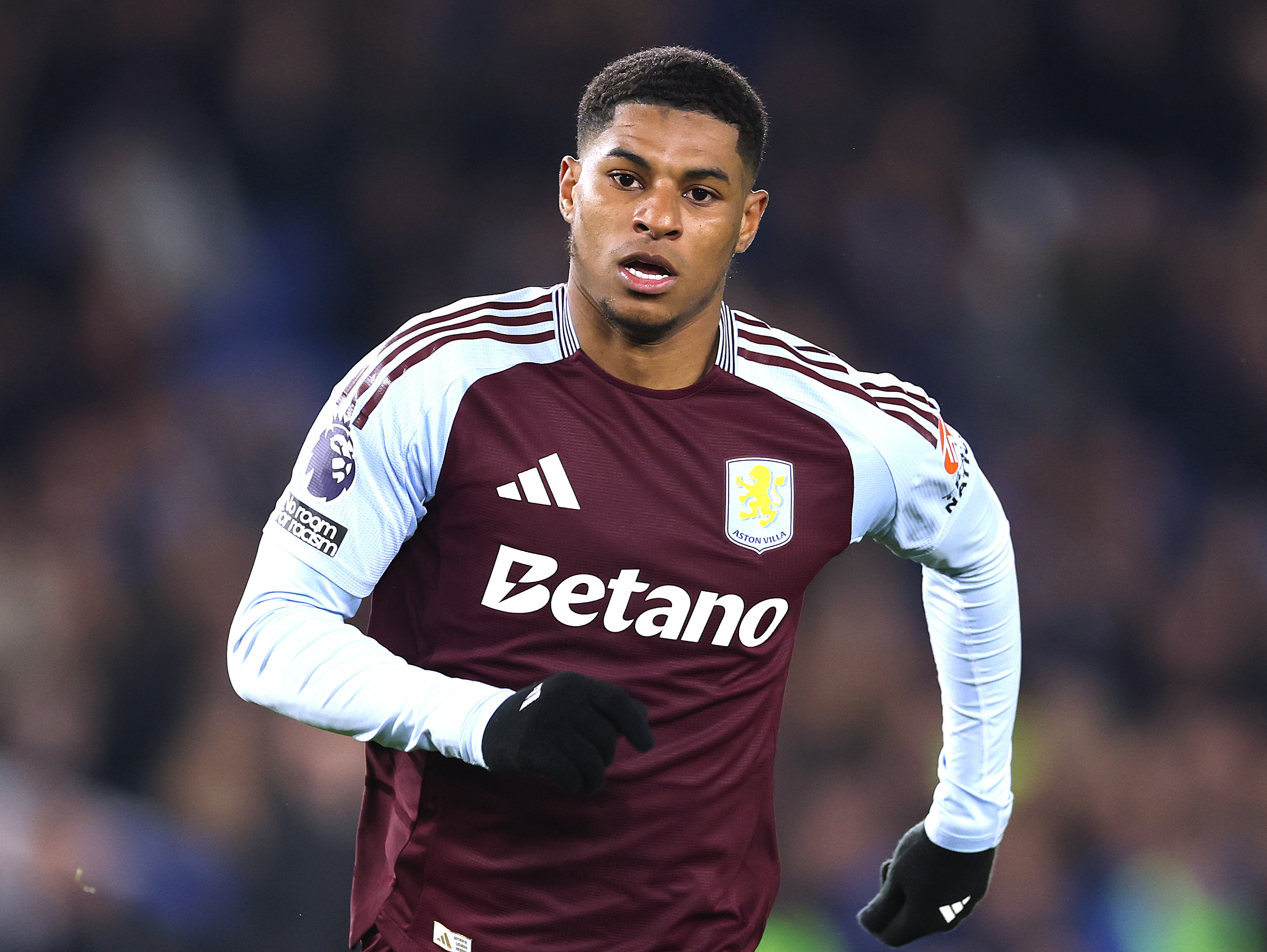 Marcus Rashford runs to celebrate his goal for Aston Villa.