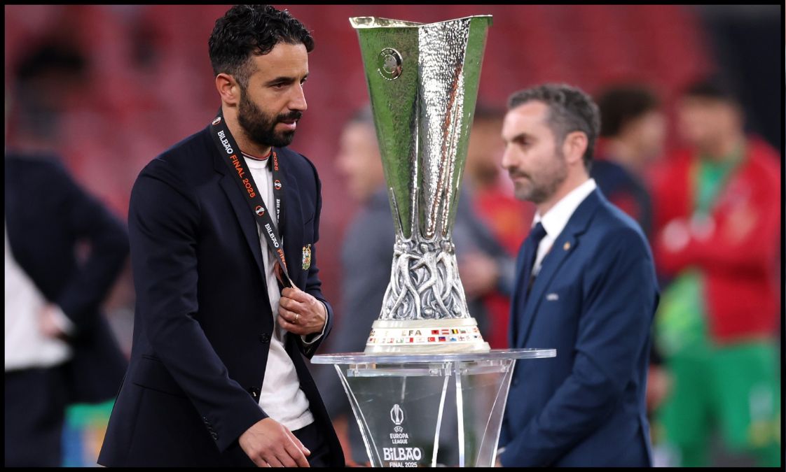 Ruben Amorim looks dejected as he walks past the Europa League trophy after losing the final.