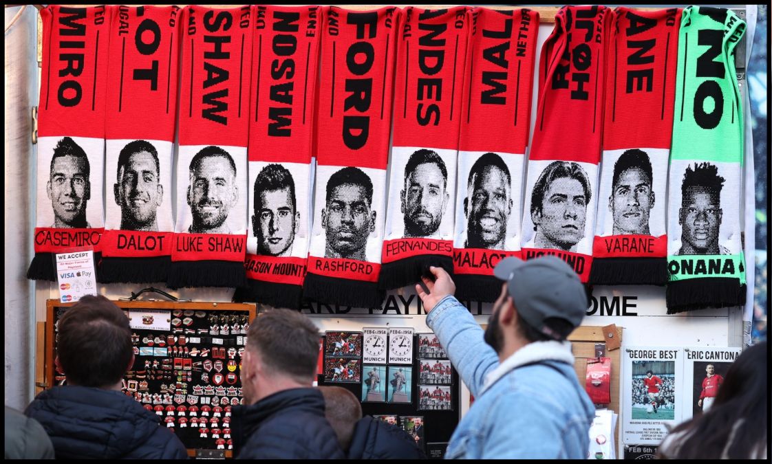 Scarves outside Old Trafford show the faces of several Man United players.
