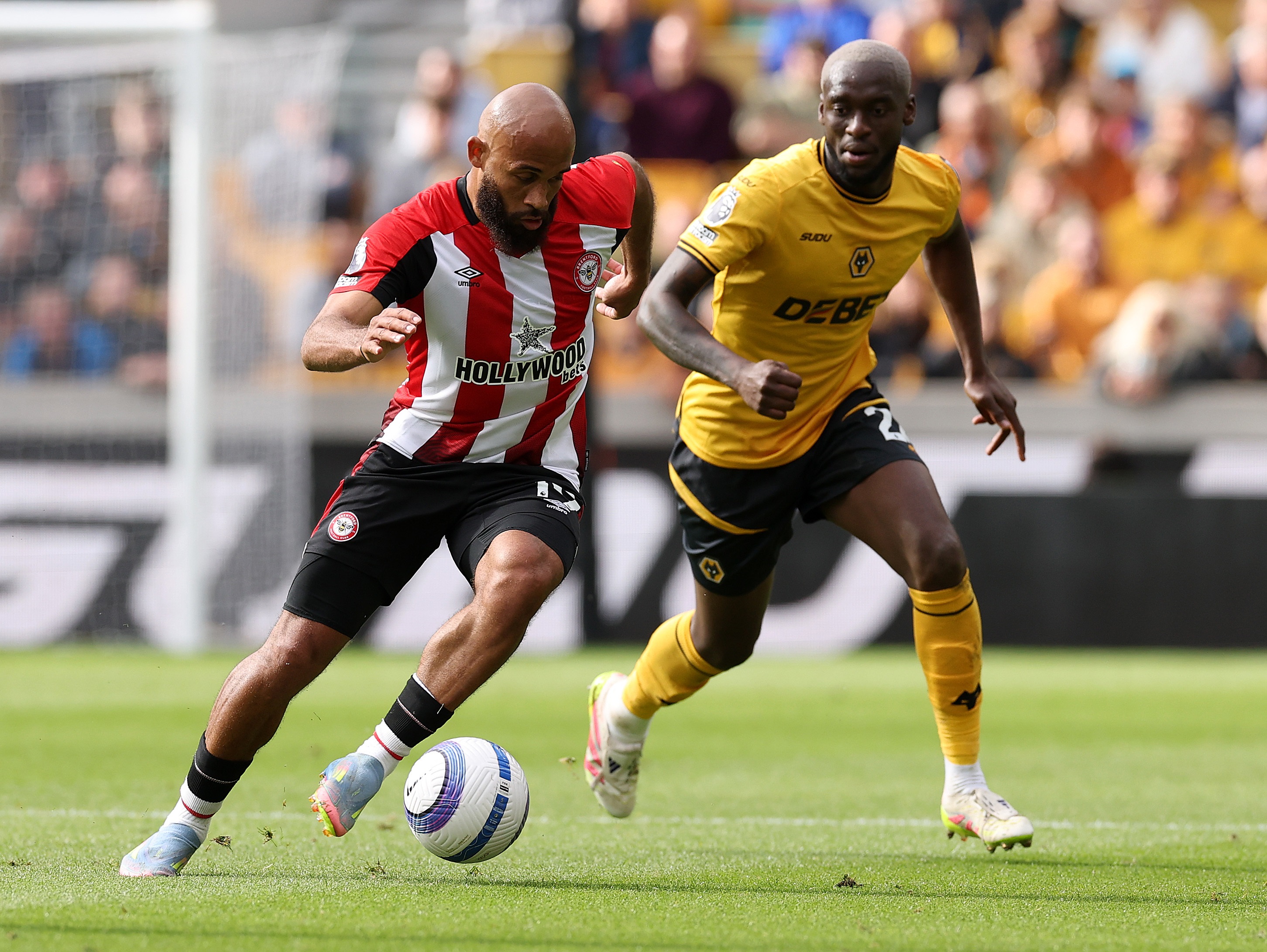 Bryan Mbeumo dribbles with the ball whilst under pressure from Toti Gomes.