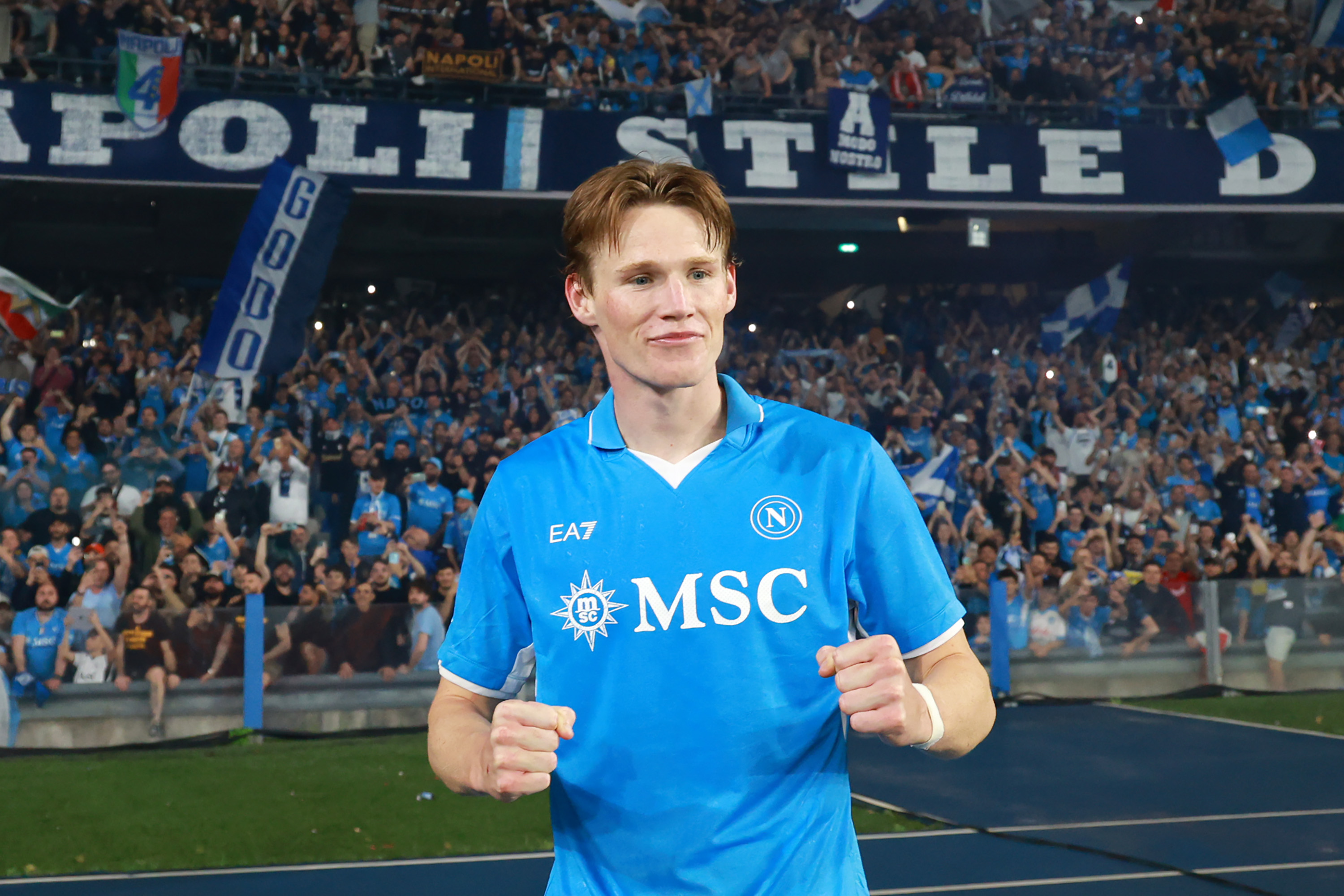 Scott McTominay celebrates with Napoli fans after the side wins the Serie A title.