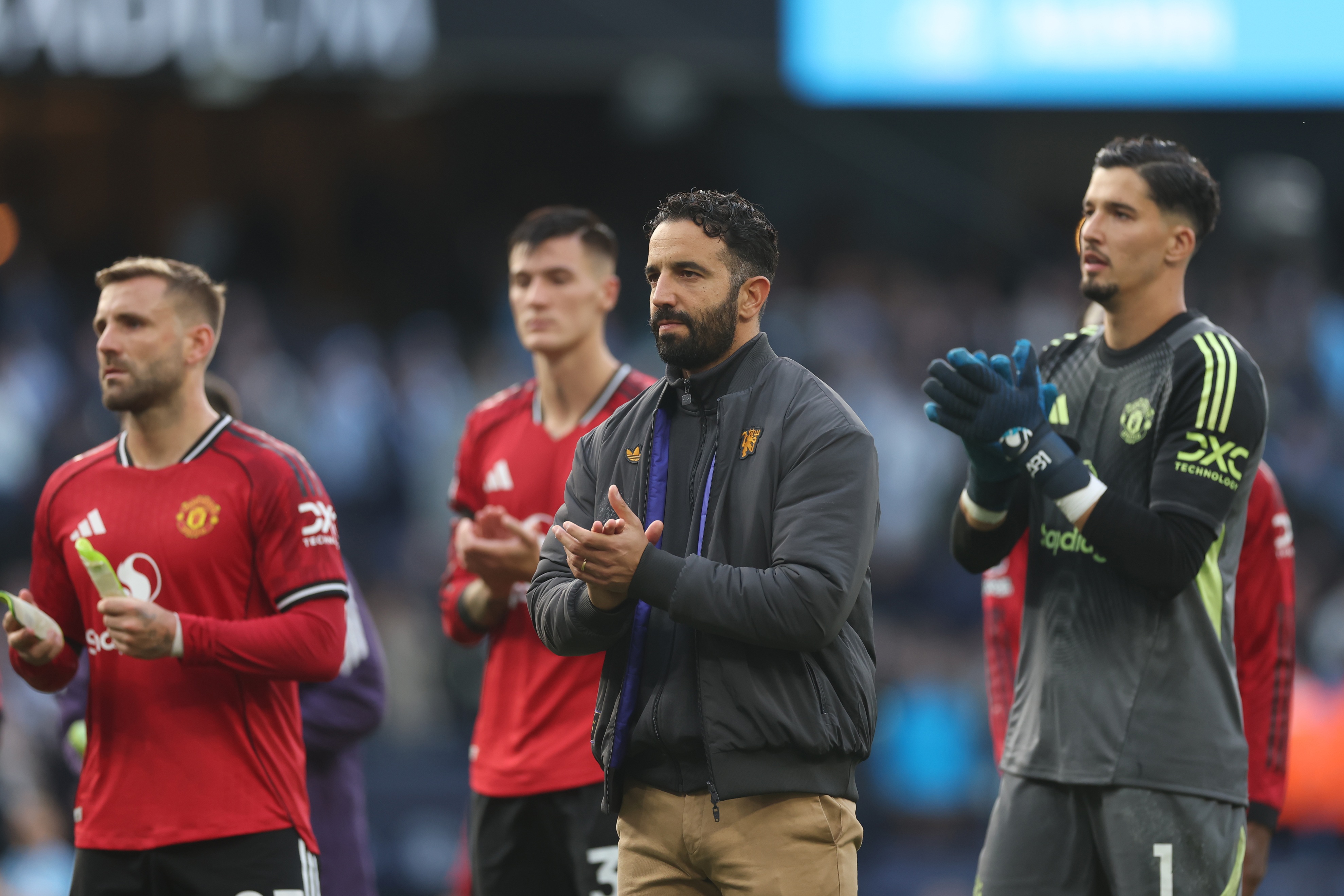 Ruben Amorim claps Manchester United fans alongside his players.