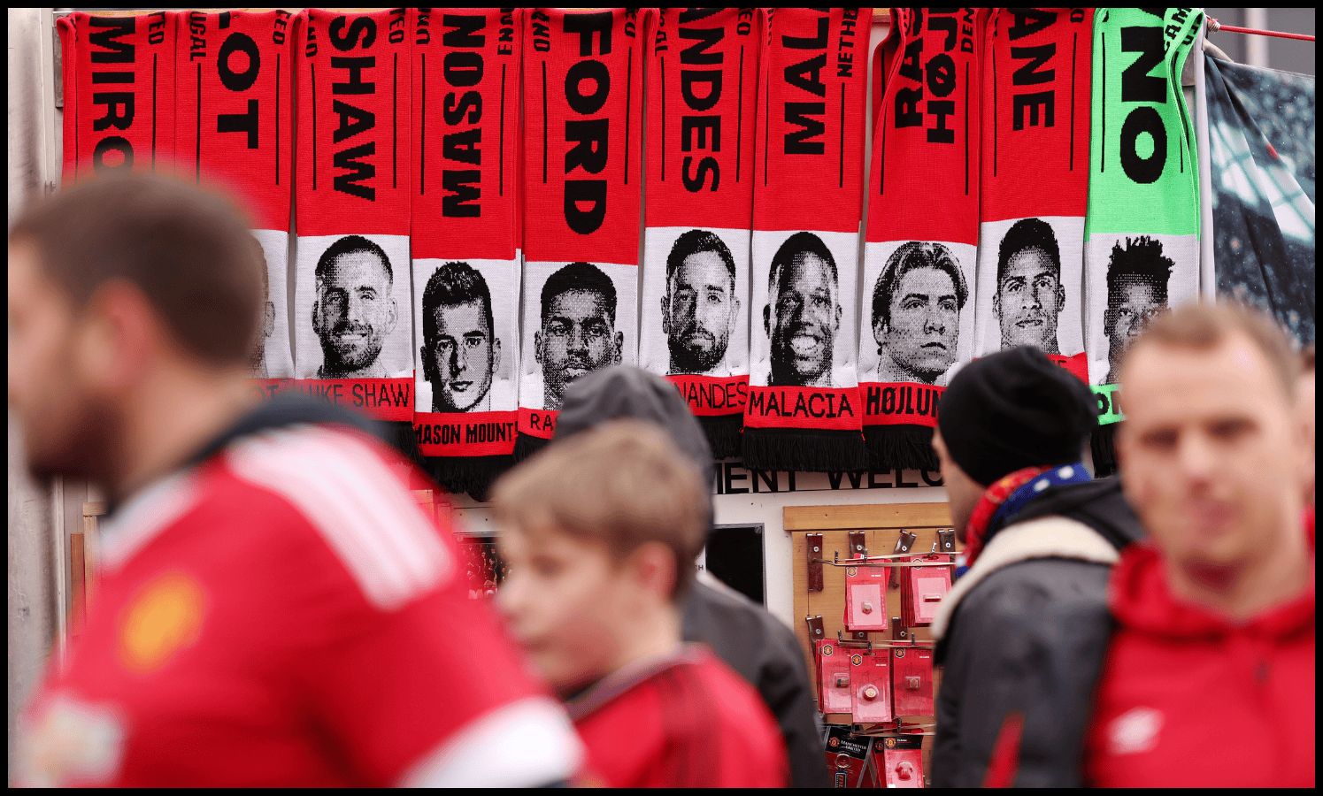 Scarves outside Old Trafford show the faces of several Man United players.