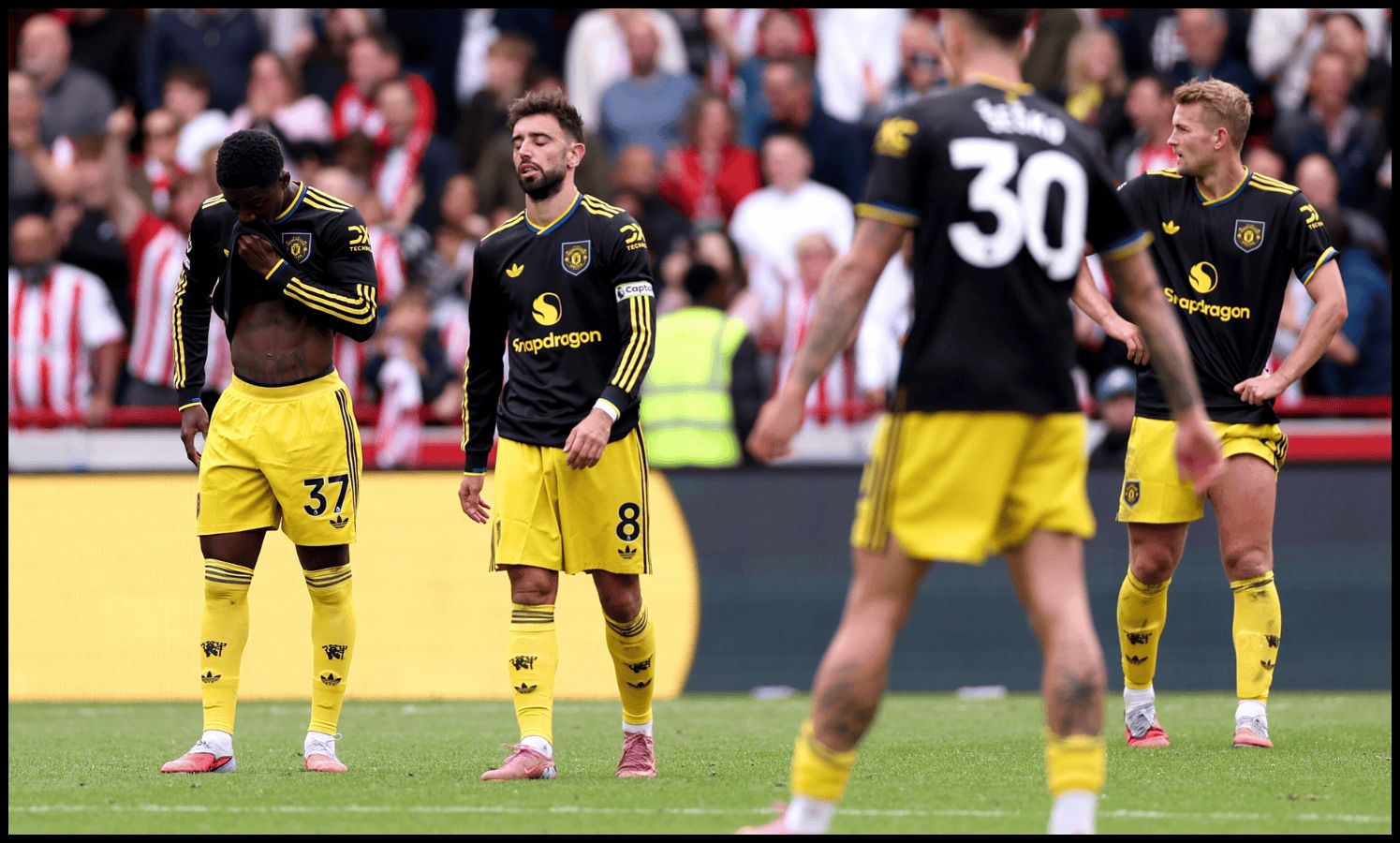 Man United players react after Brentford score their third goal.
